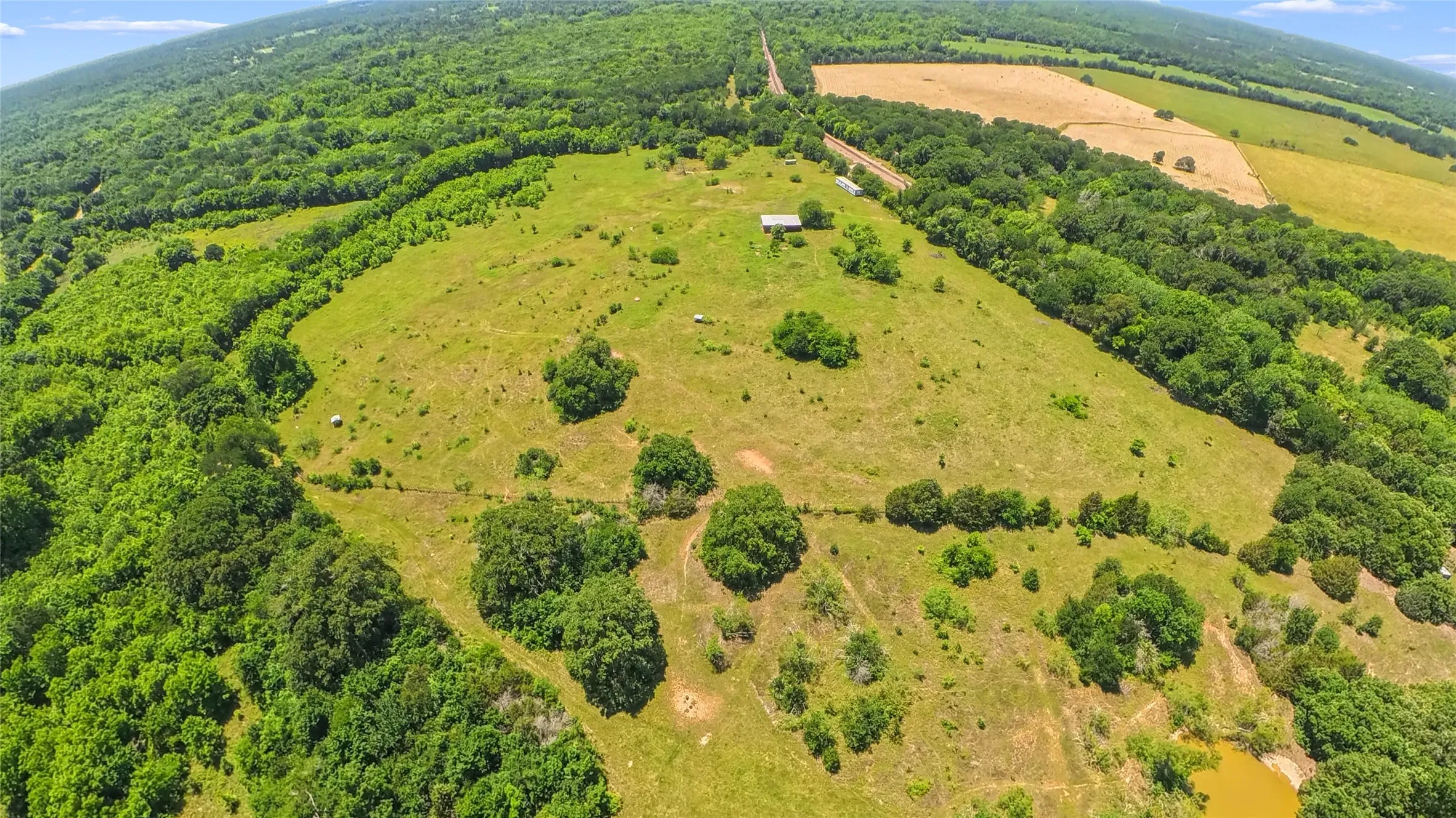 Expansive acreage featuring rolling pastures and mature tree lines