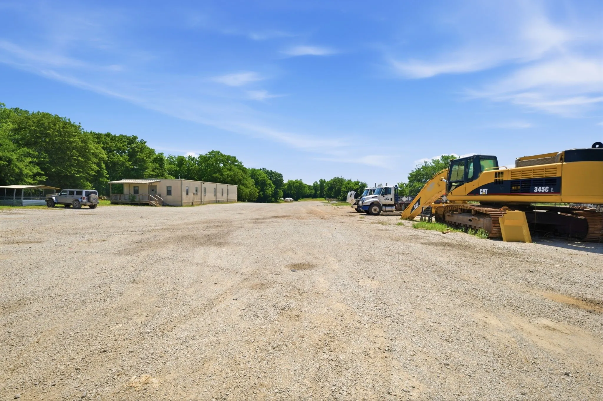 Expansive gravel lot with multiple structures