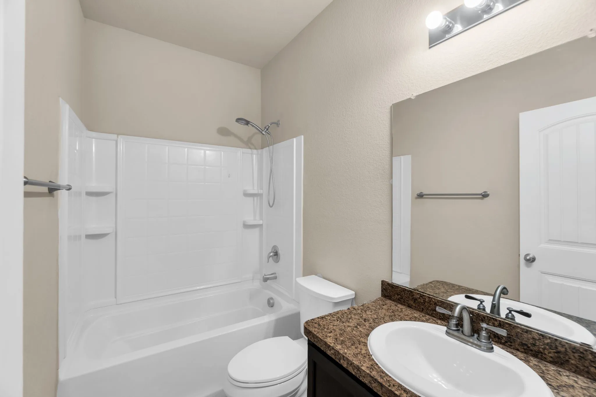 Full bathroom featuring bathtub / shower combination, toilet, and vanity