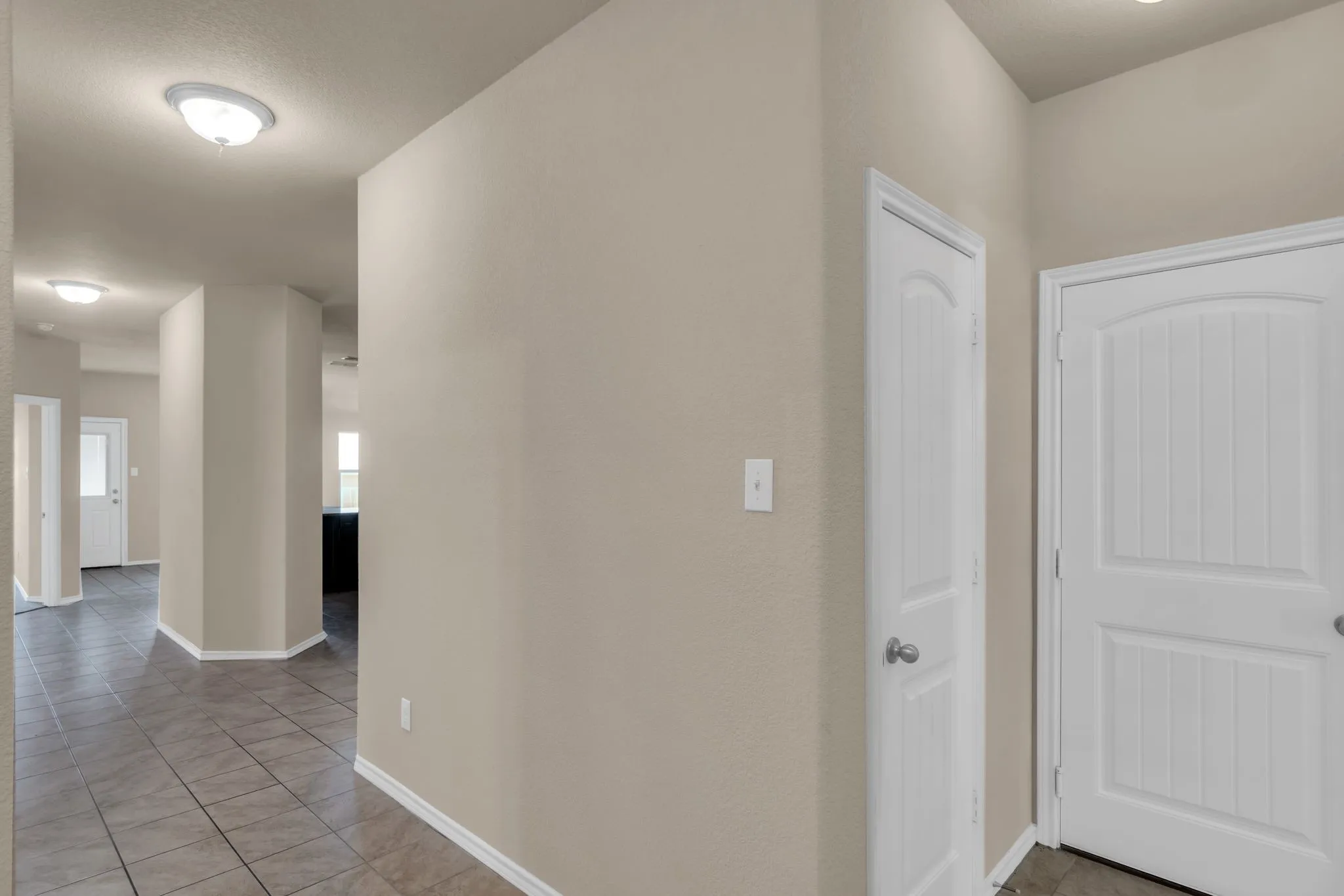 Corridor featuring tile flooring