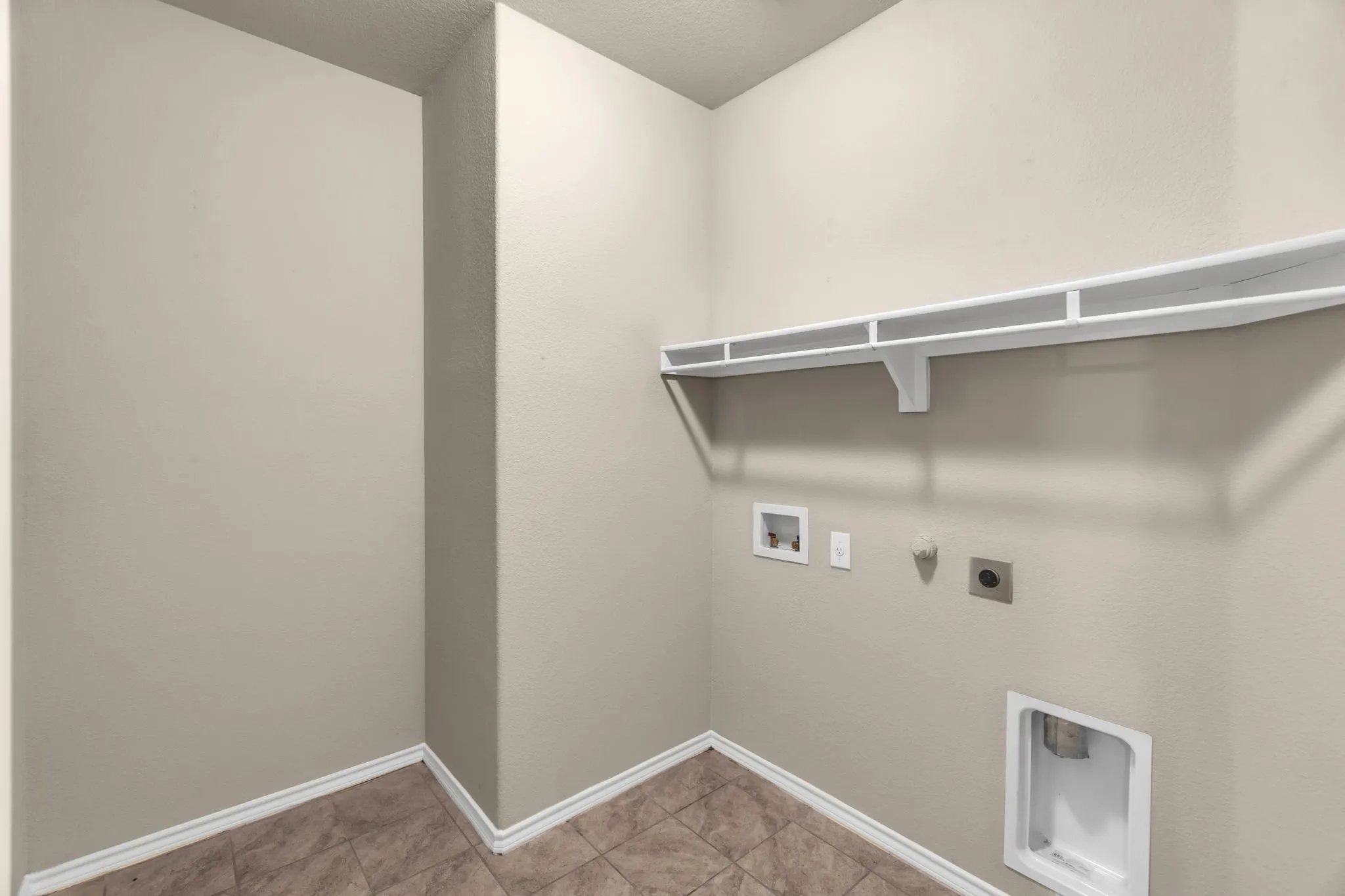 Laundry room featuring gas dryer hookup, tile flooring, hookup for an electric dryer, and washer hookup