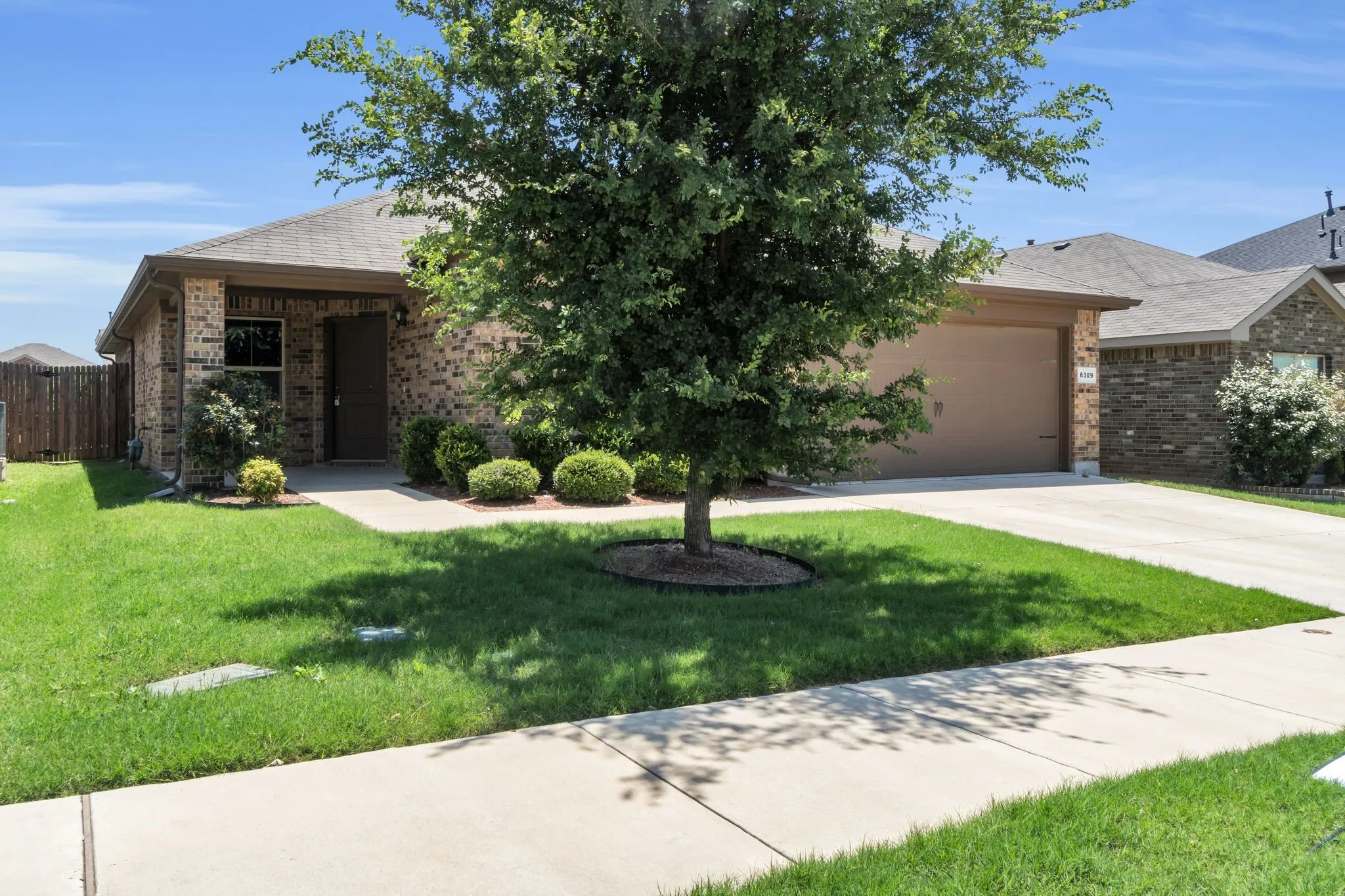 View of front of home with a front lawn and a garage