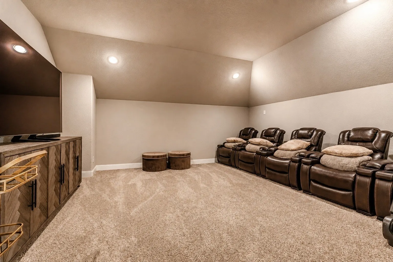Entertainment room featuring a vaulted ceiling with recessed lighting