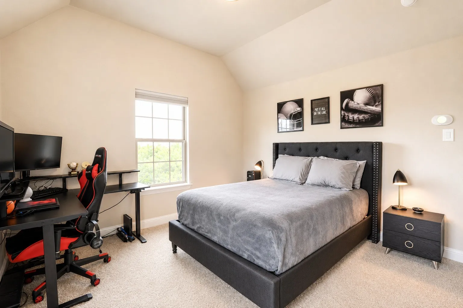 Carpeted bedroom featuring vaulted ceilings, a window with exterior views, and a neutral color palette