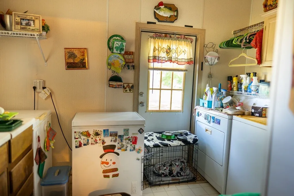 Dedicated utility area featuring a window with natural light, a side-by-side washer and dryer, and built-in upper cabinetry