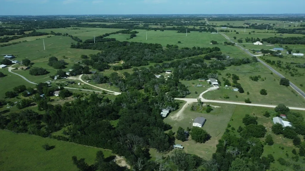 Expansive acreage featuring significant tree coverage and open grassland areas