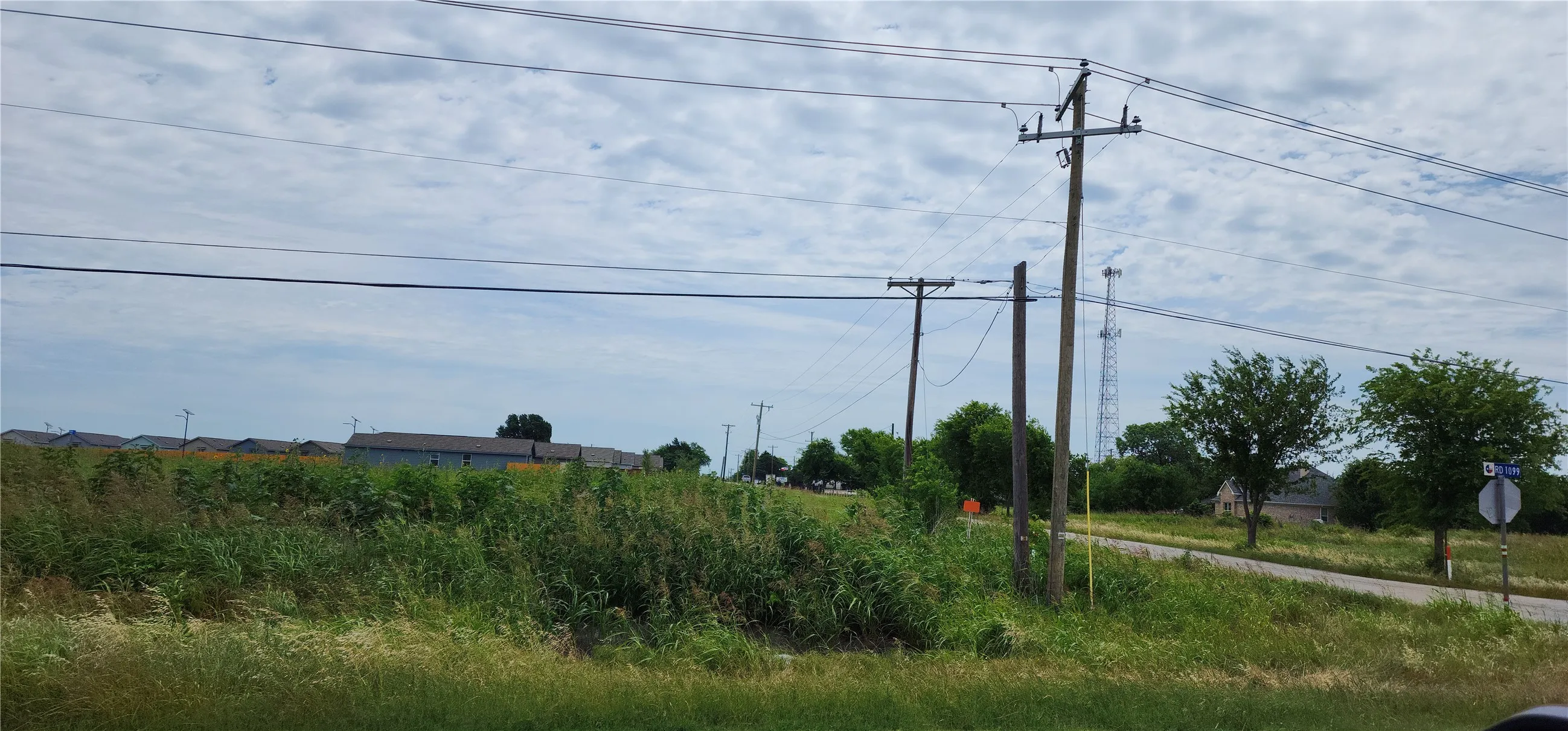More residential construction directly across CR-1099 from the property.