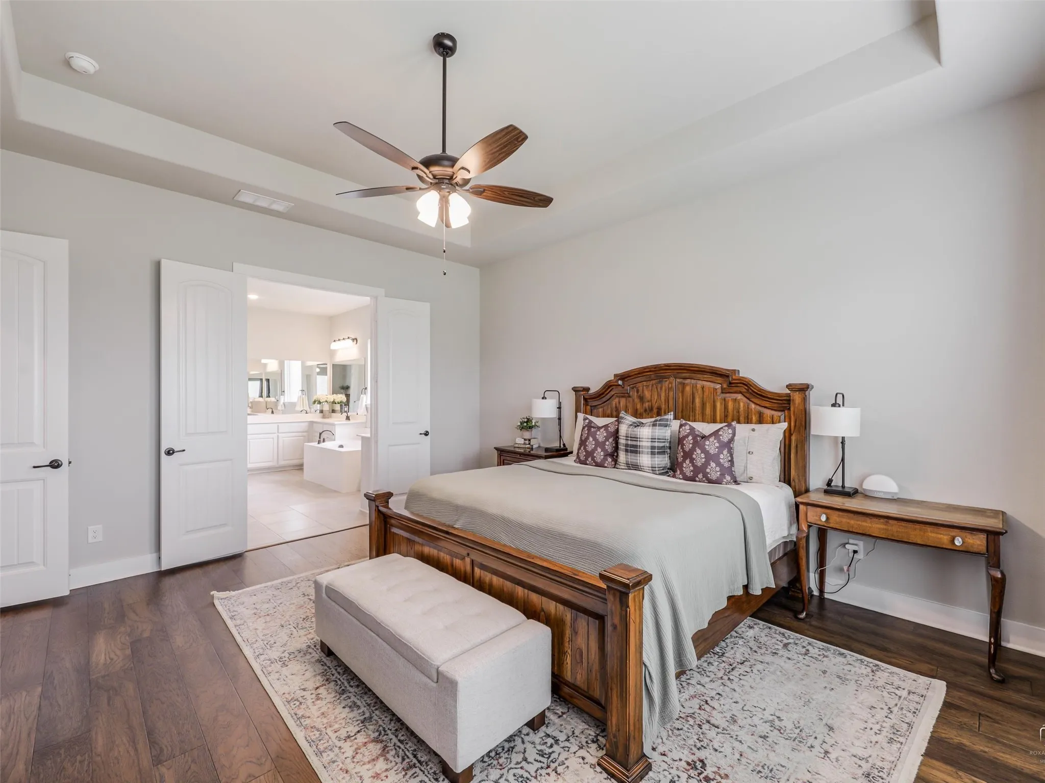 Spacious primary retreat at 544 Majors Road with ample room for a king-sized set, tray ceilings, and peaceful views of the private Van Alstyne acreage.