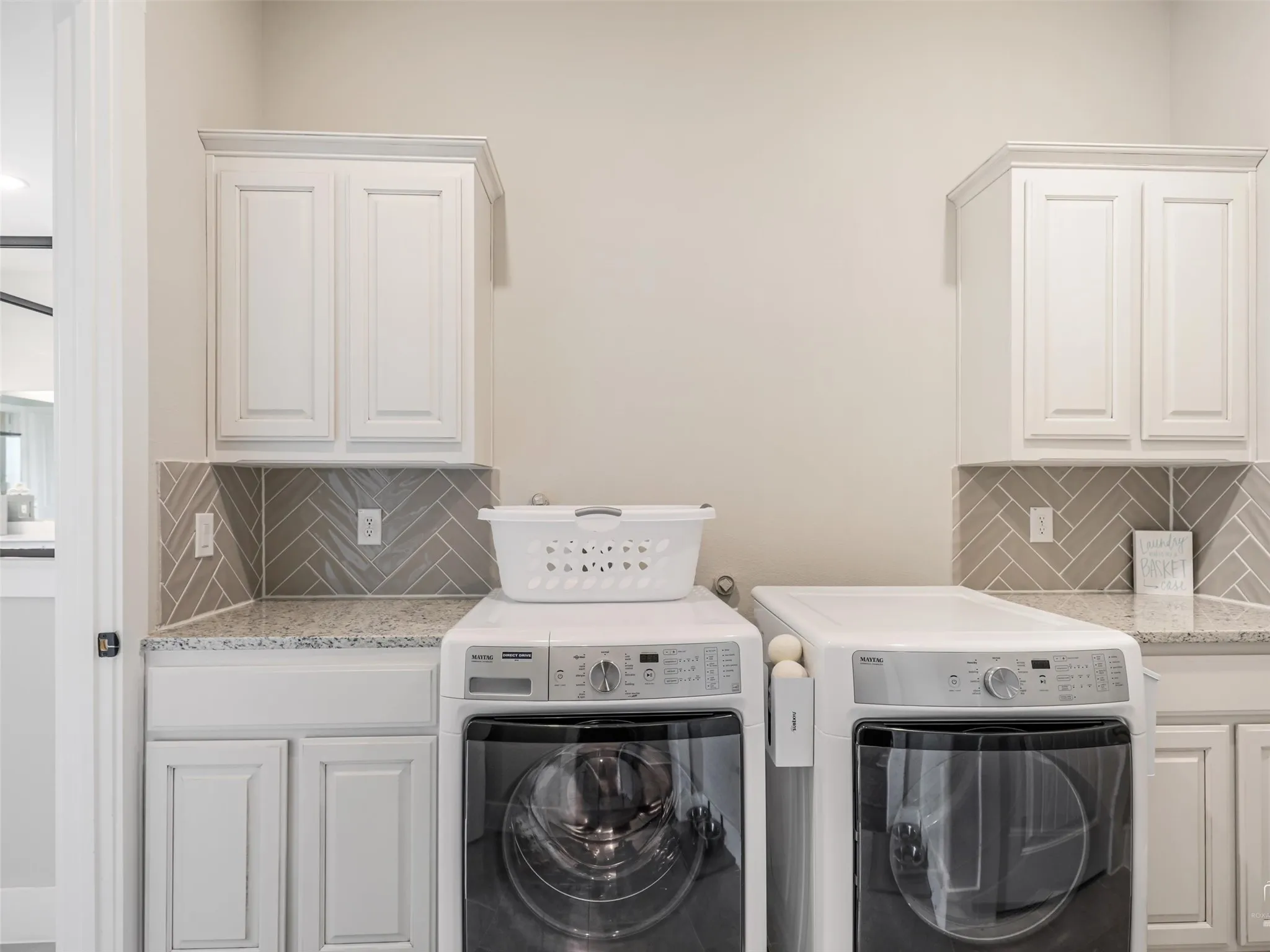 Spacious laundry room at 544 Majors Road with built-in cabinetry and direct back entry access from the primary suite in this Van Alstyne, Texas estate.