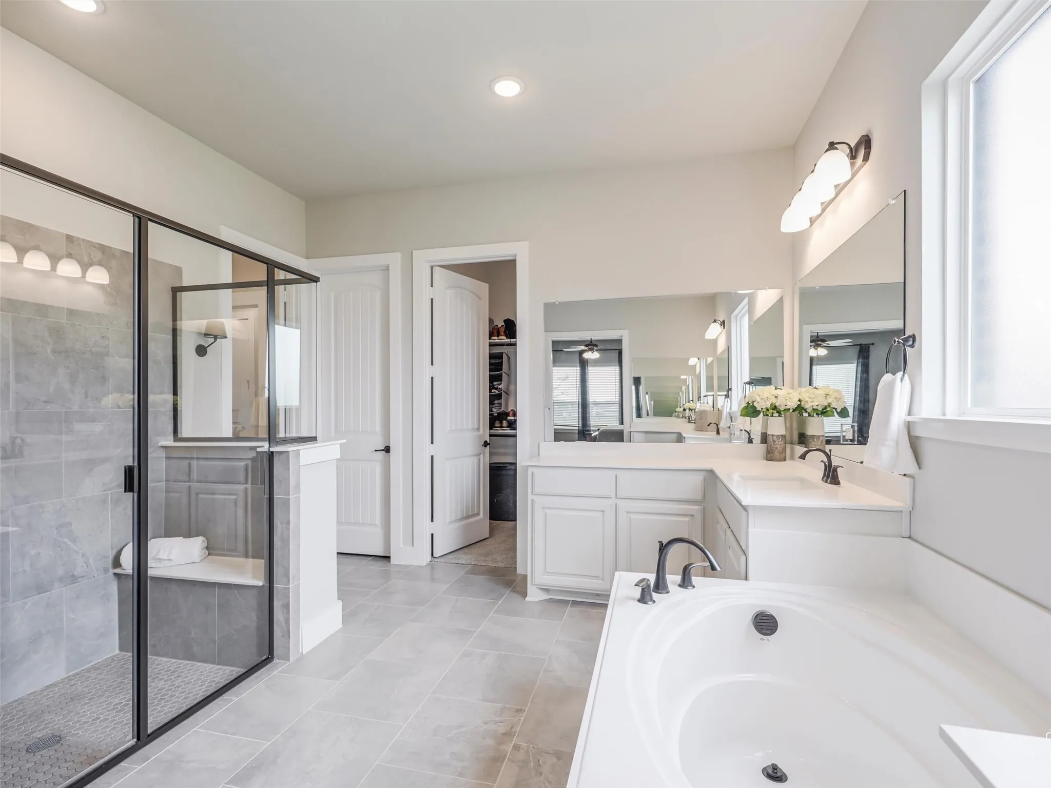 Oversized separate shower with a convenient built-in seat at 544 Majors Road, part of the spa-like primary bathroom in this Van Alstyne estate on 1 acre.