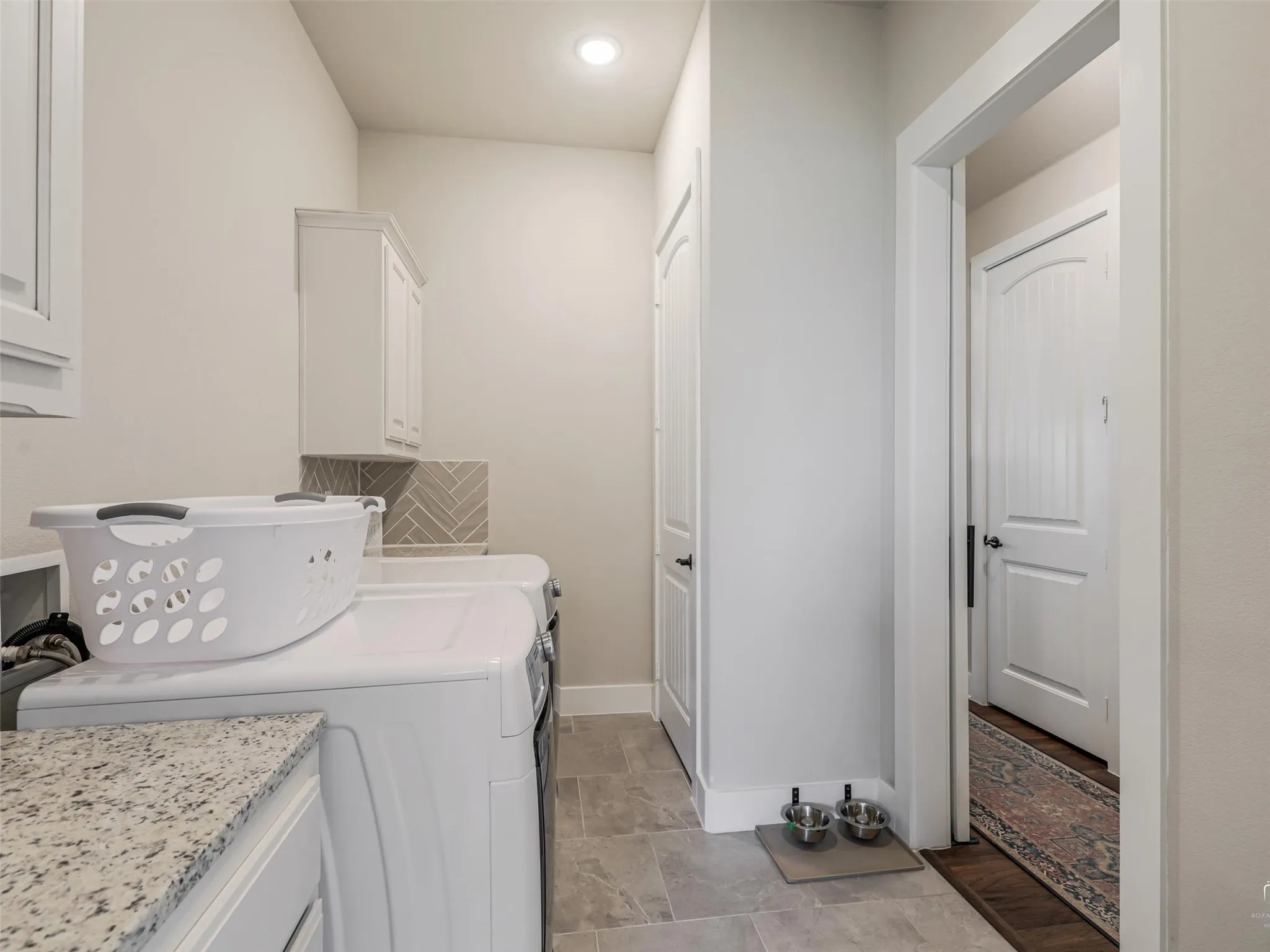 Spacious laundry room at 544 Majors Road with built-in cabinetry and direct back entry access from the primary suite in this Van Alstyne, Texas estate.