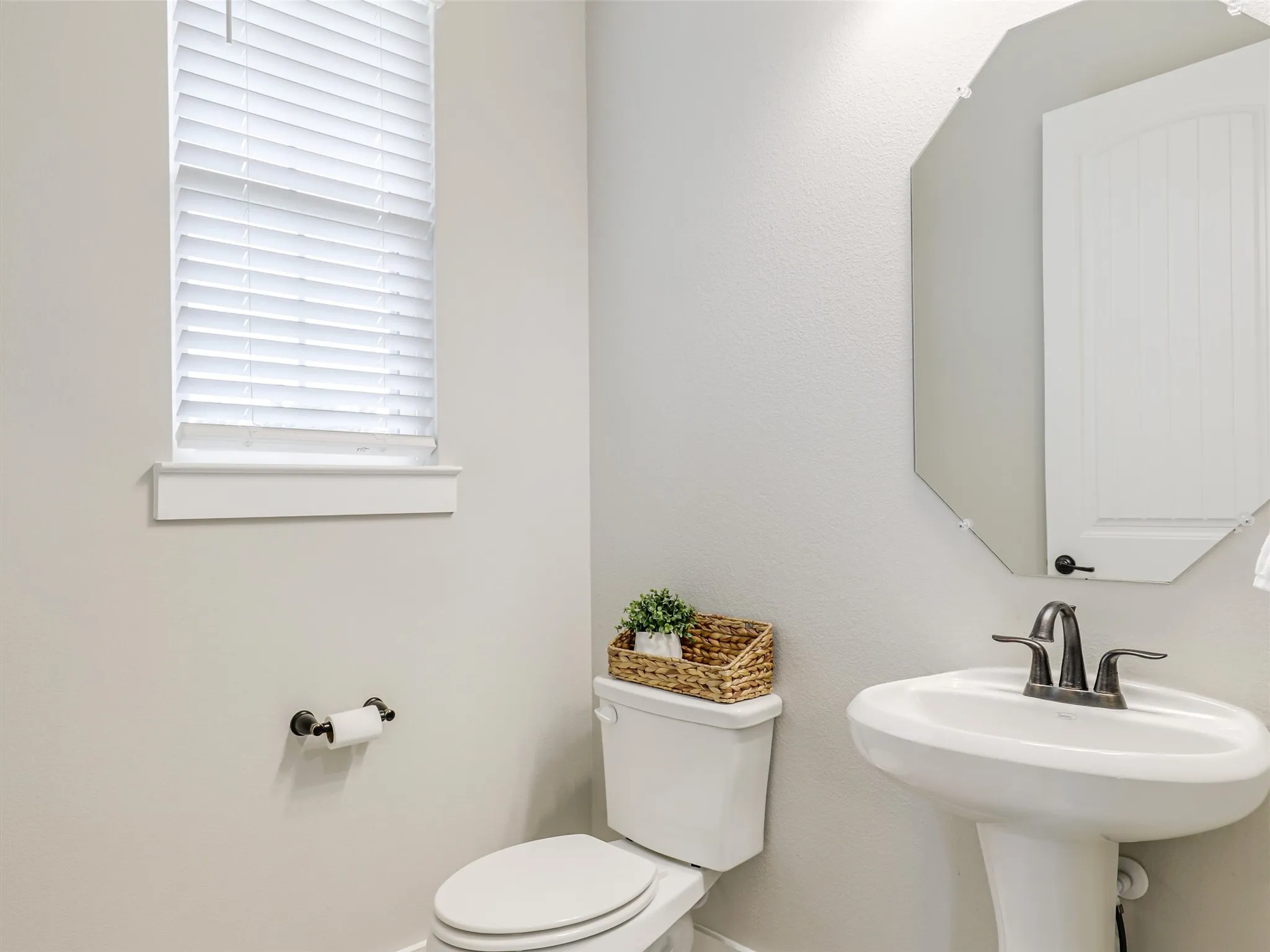 Convenient main-floor powder room at 544 Majors Road, one of 3.5 bathrooms in this 4-bedroom Van Alstyne estate on a 1-acre pipe-fenced lot.