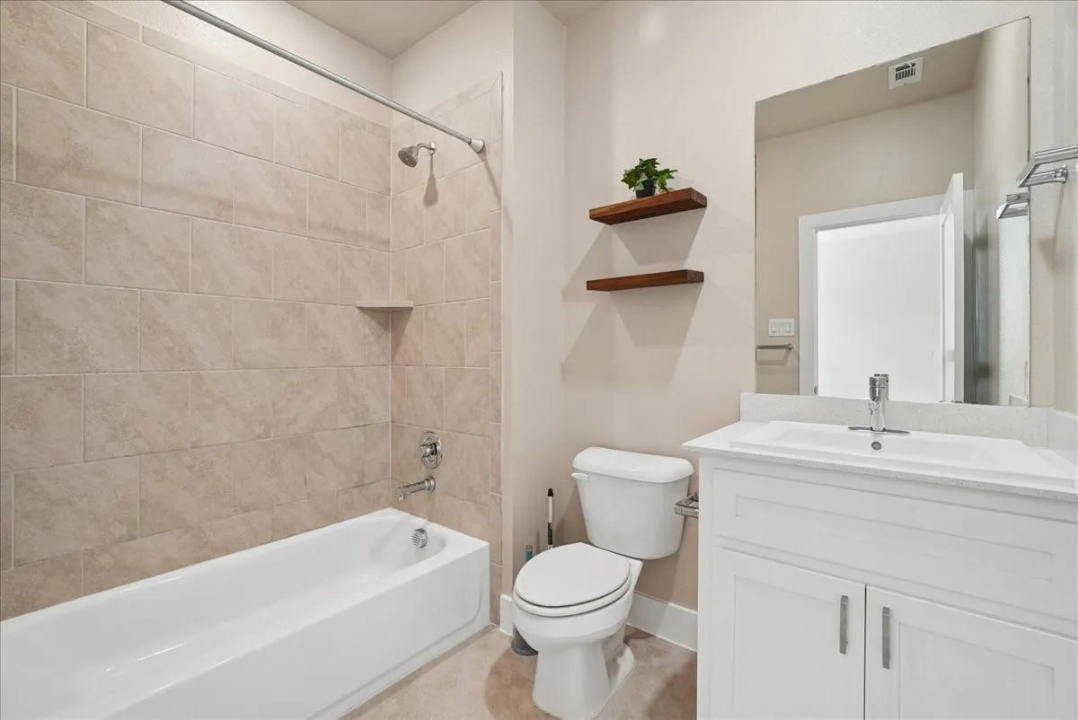 Bathroom featuring a tub/shower combination with subway tile surround, an integrated shower niche, and chrome fixtures