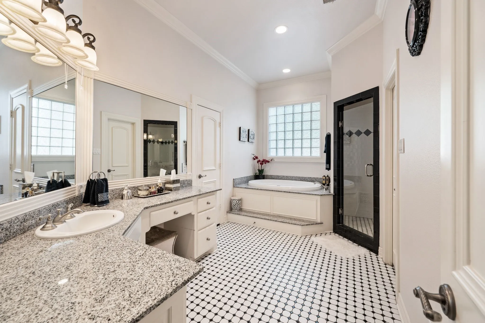 White vanity with an integrated sink and light-colored speckled countertop