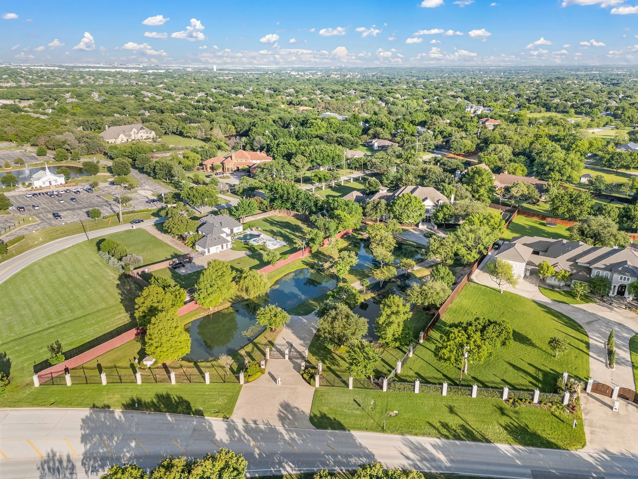 Extensive property featuring a private pond, mature trees, and expansive green spaces