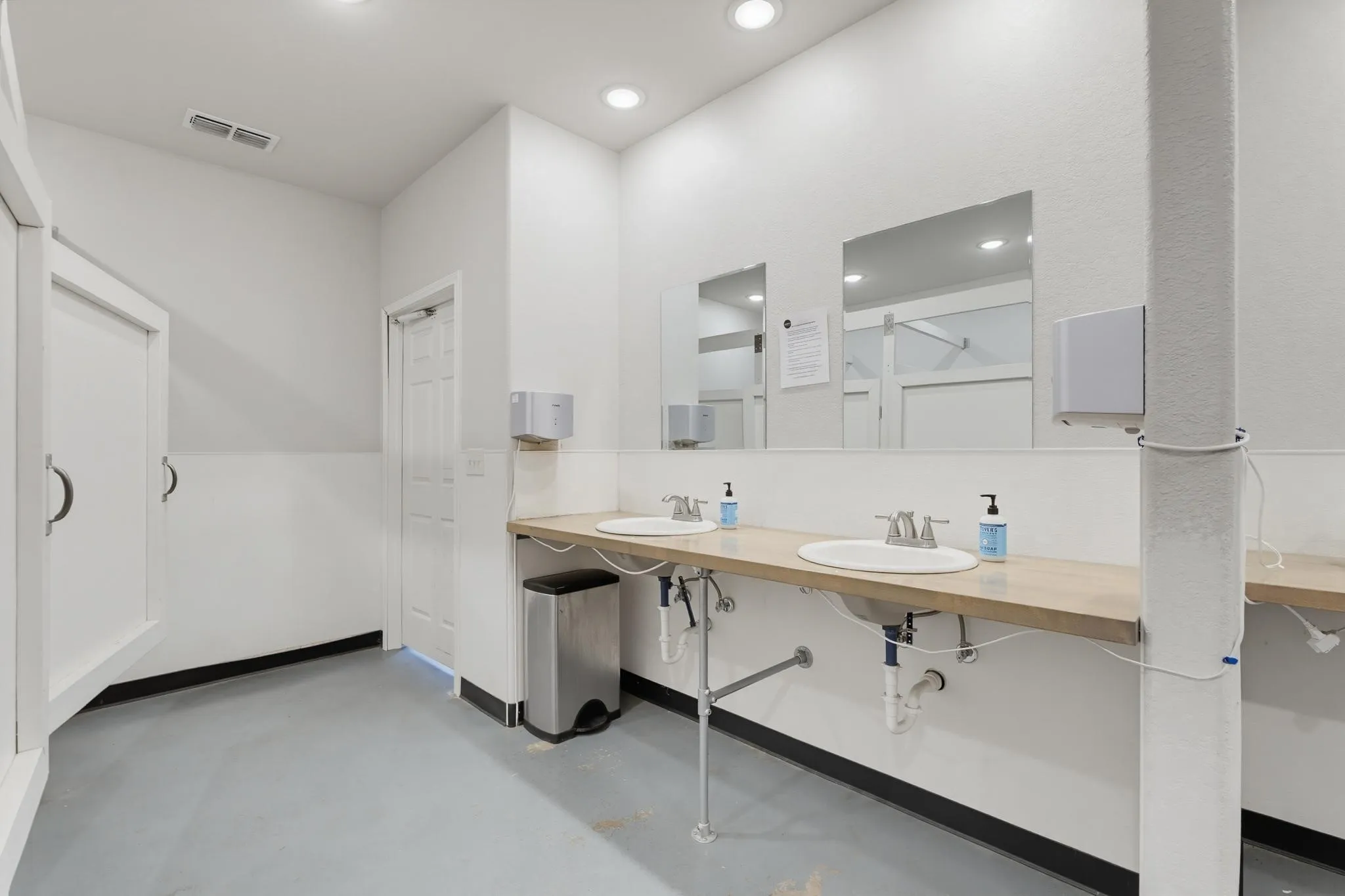 Dual vanity with integrated sinks, expansive countertop, and recessed lighting