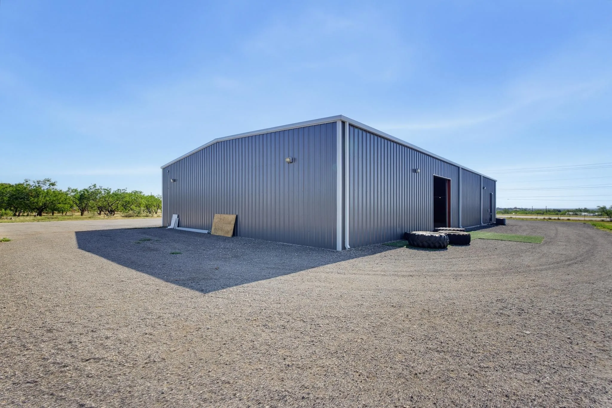 Corrugated metal building with a light gray finish