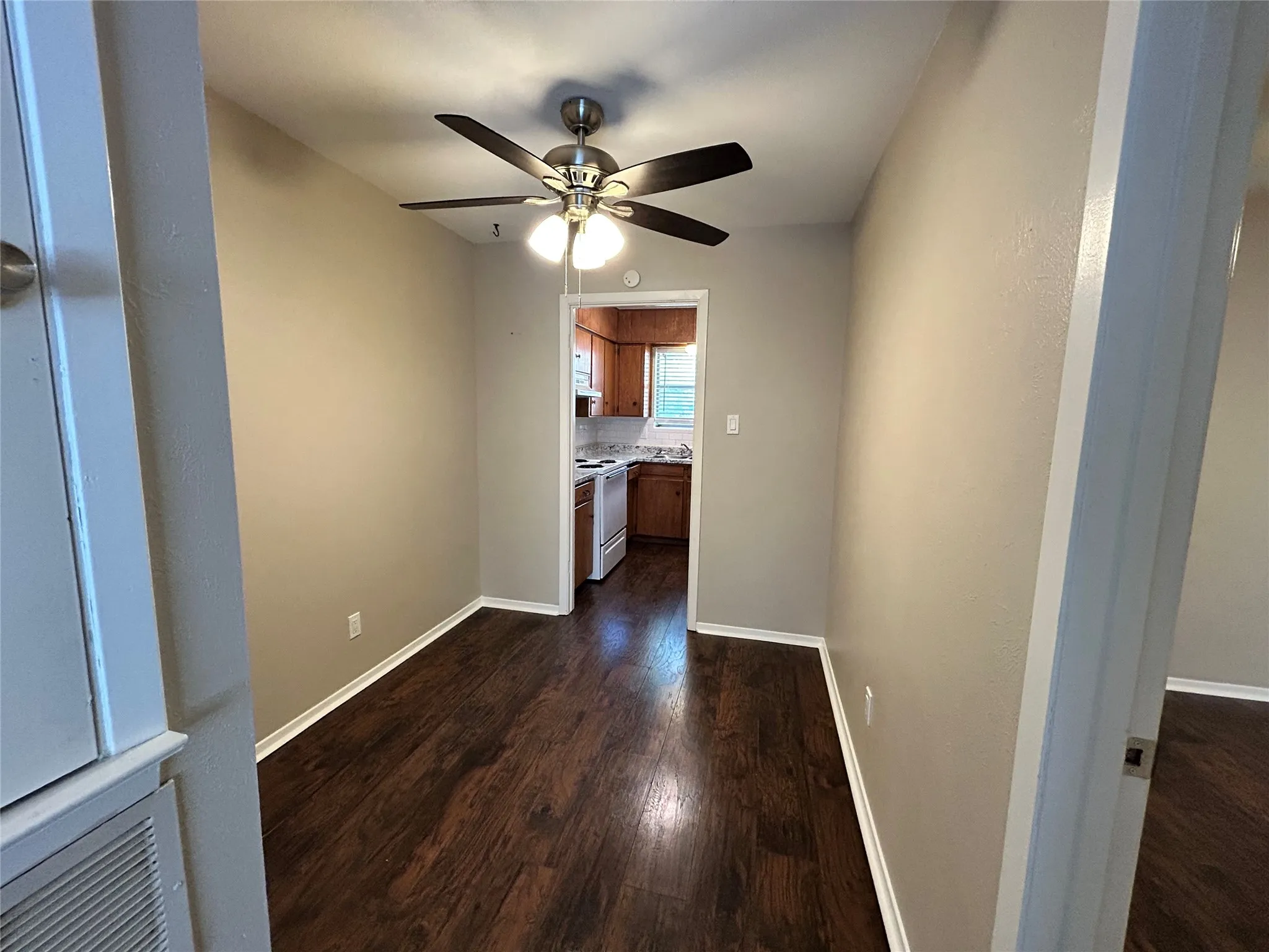 Notice the peek into the kitchen from this room.