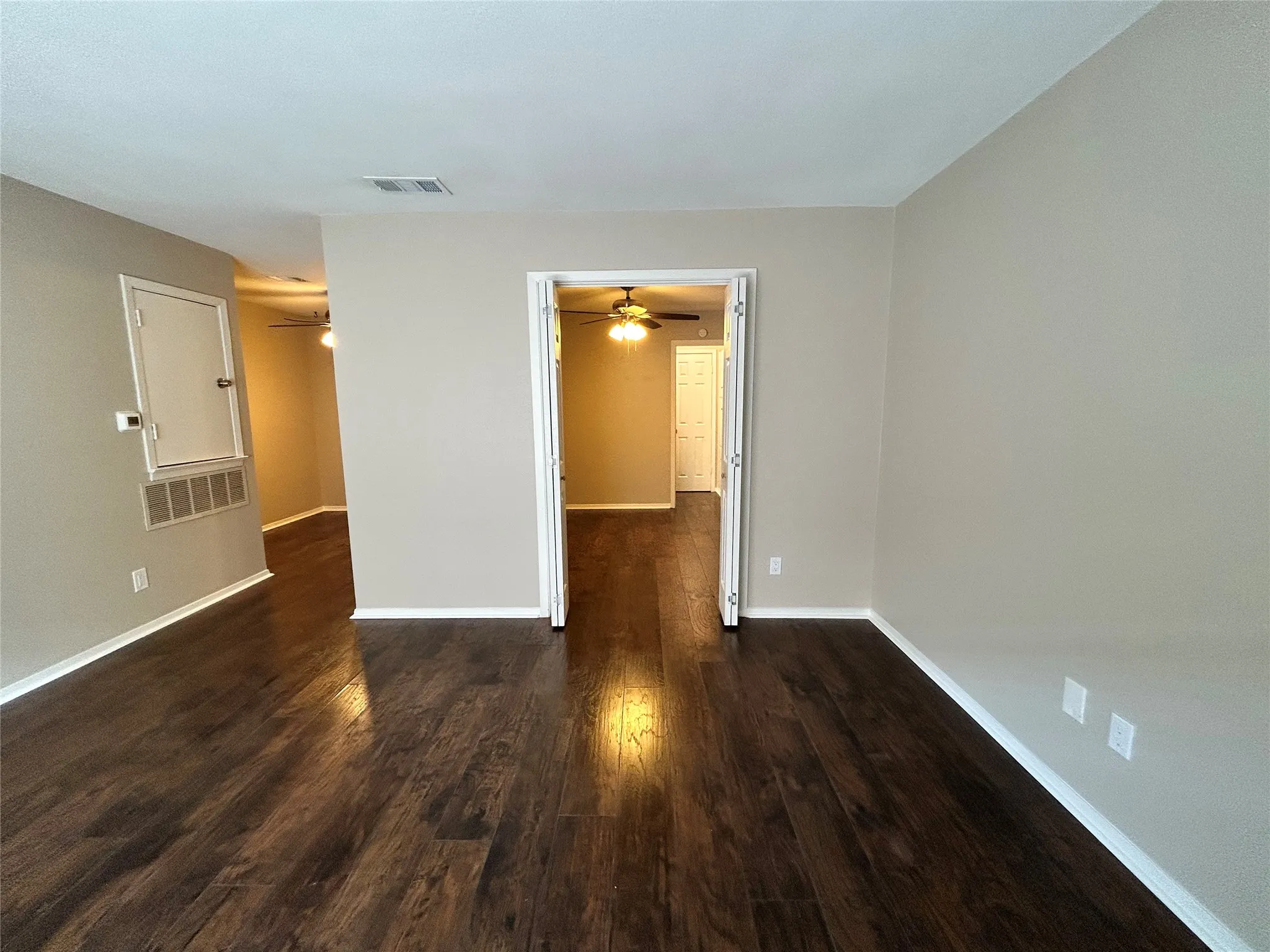 Wood-finish flooring throughout, light neutral wall tones, and white trim