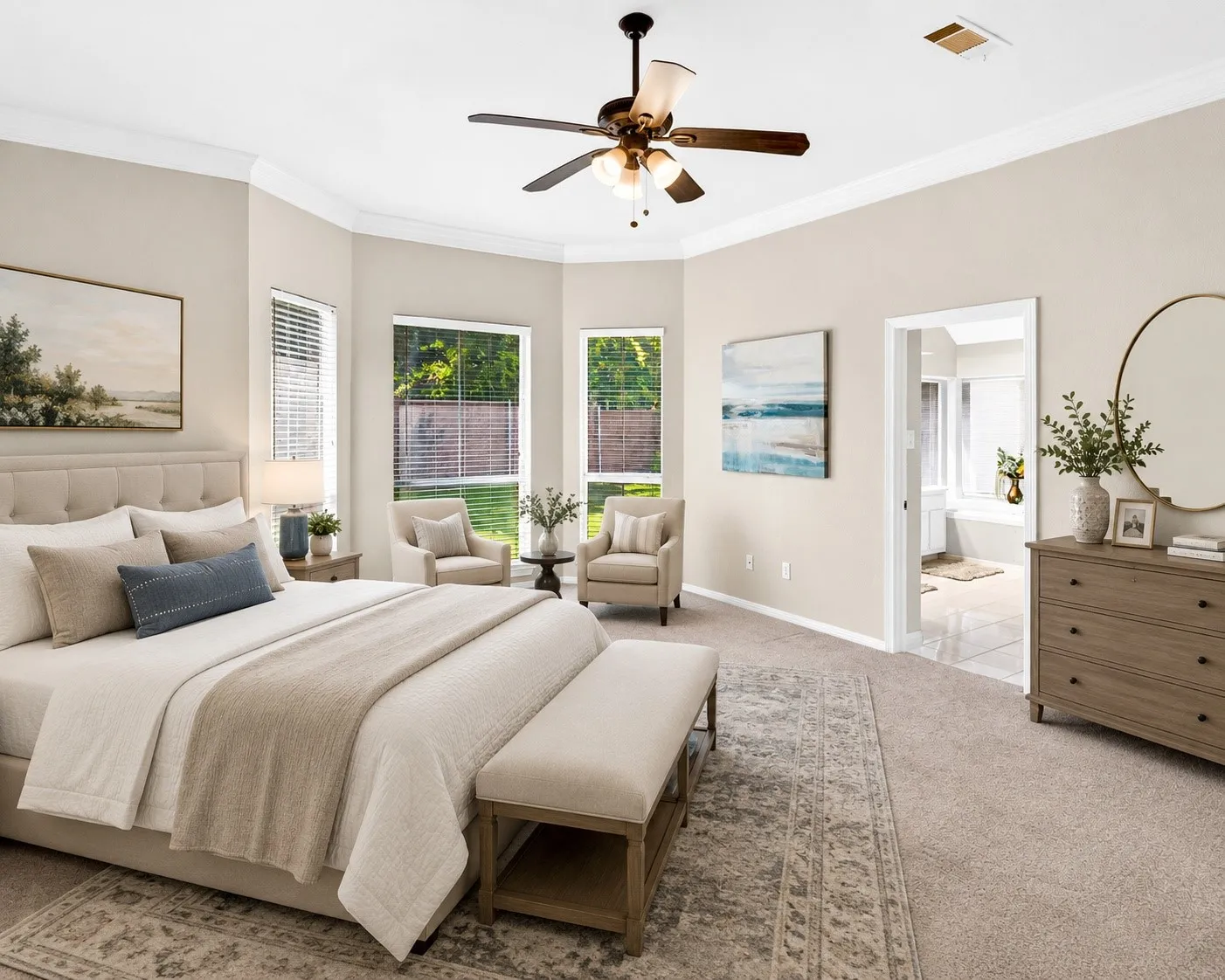 Carpeted room featuring a bay window with multiple large windows, crown molding, and a ceiling fan with integrated lighting