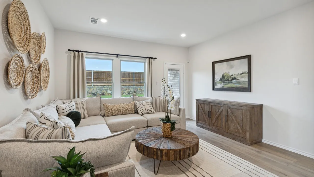Bright living space featuring light-toned walls, recessed lighting, and wood-finish flooring