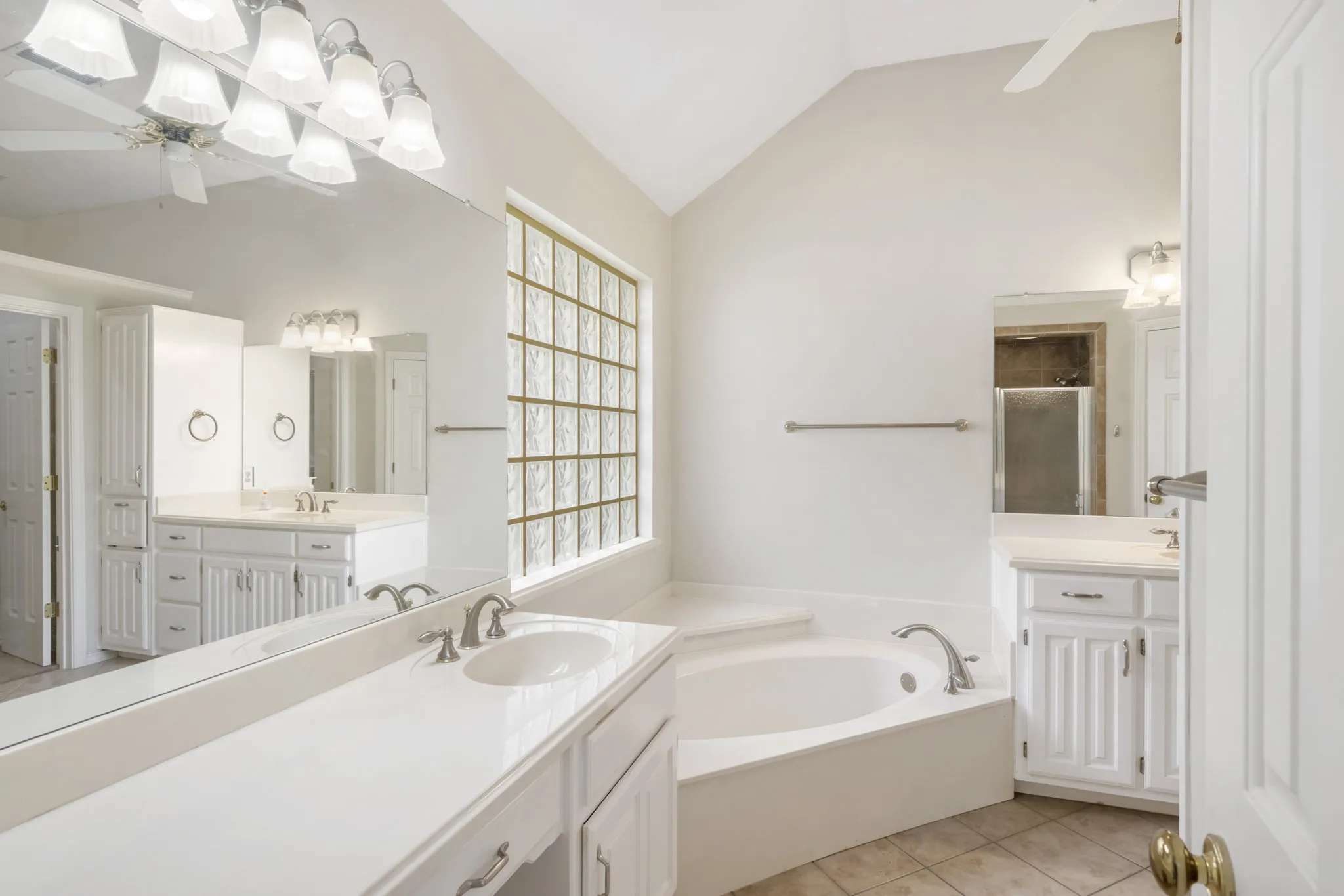 Luxurious primary bath with double vanities and a soaking tub