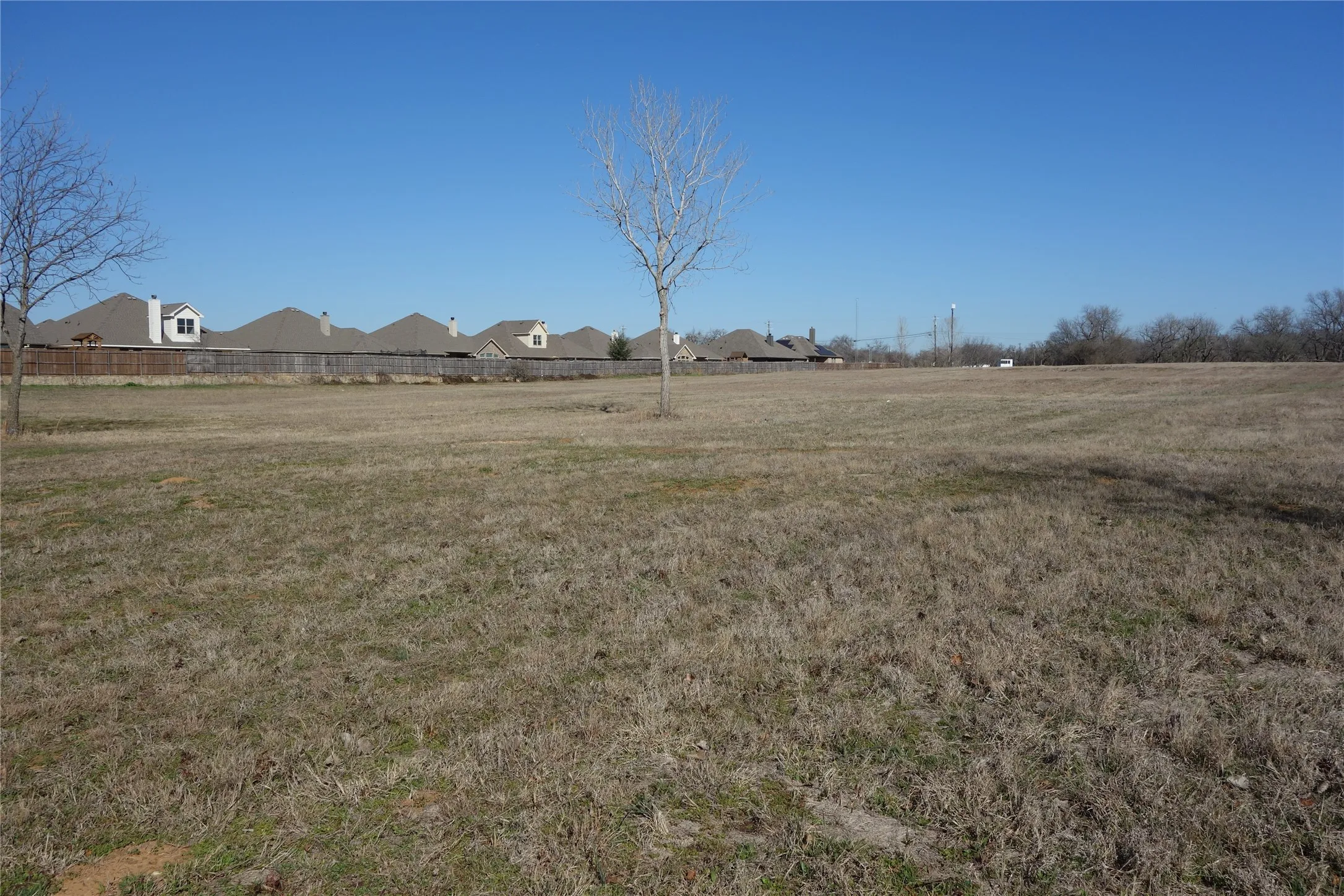 Expansive lot featuring a cleared, level terrain and a distant treeline