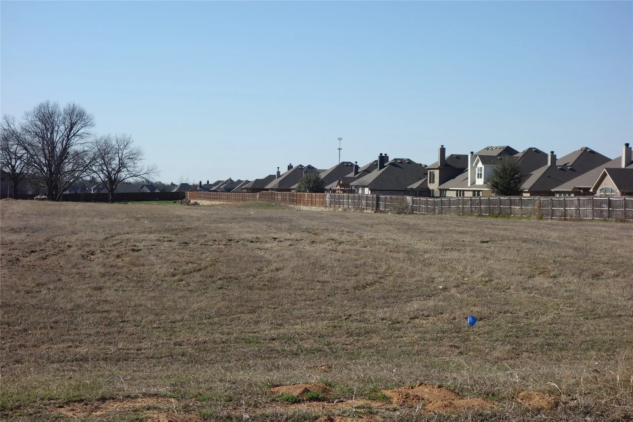 Expansive cleared lot featuring level ground and established perimeter fencing