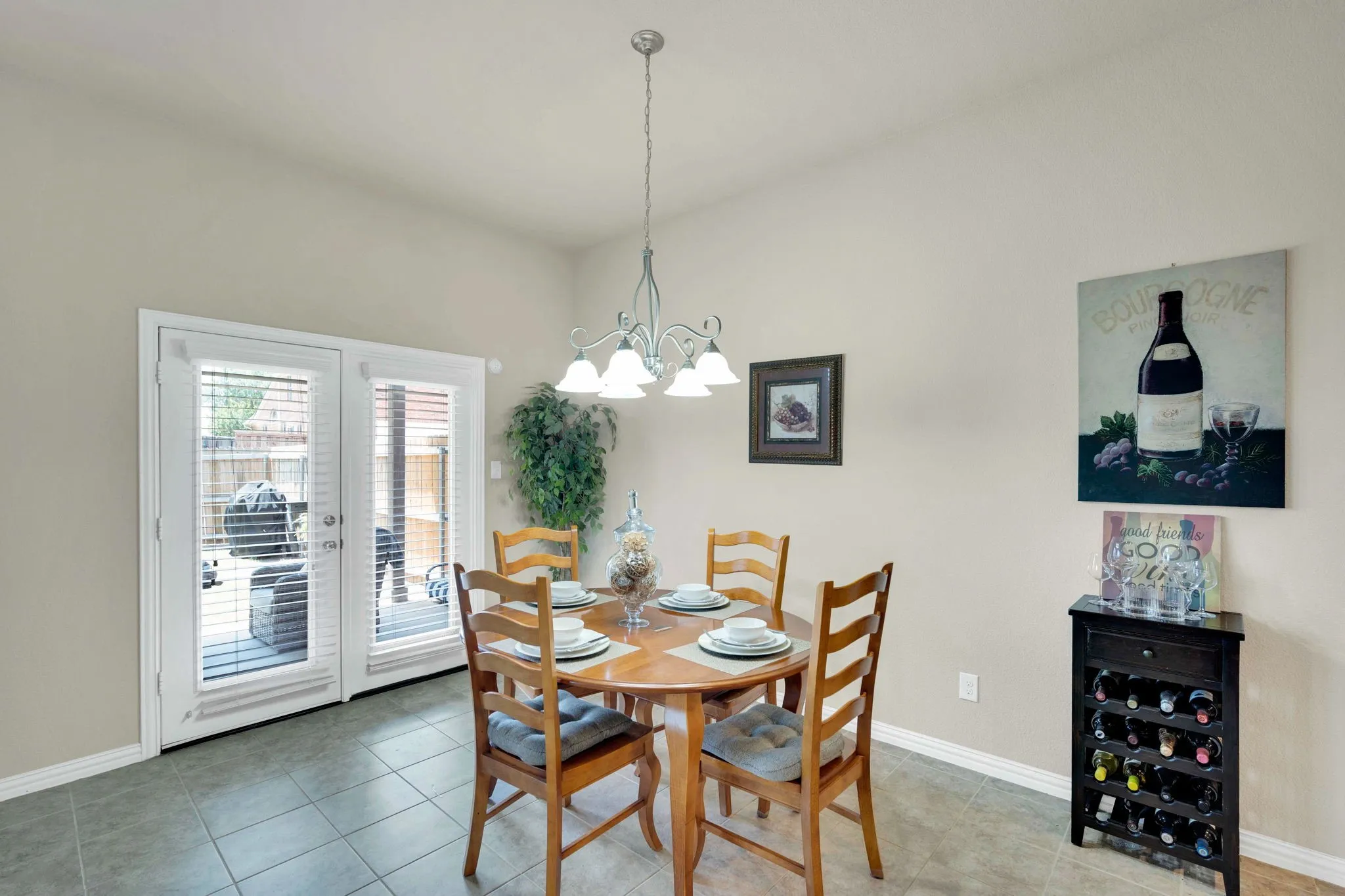 Dining area featuring light-toned walls and square tile flooring