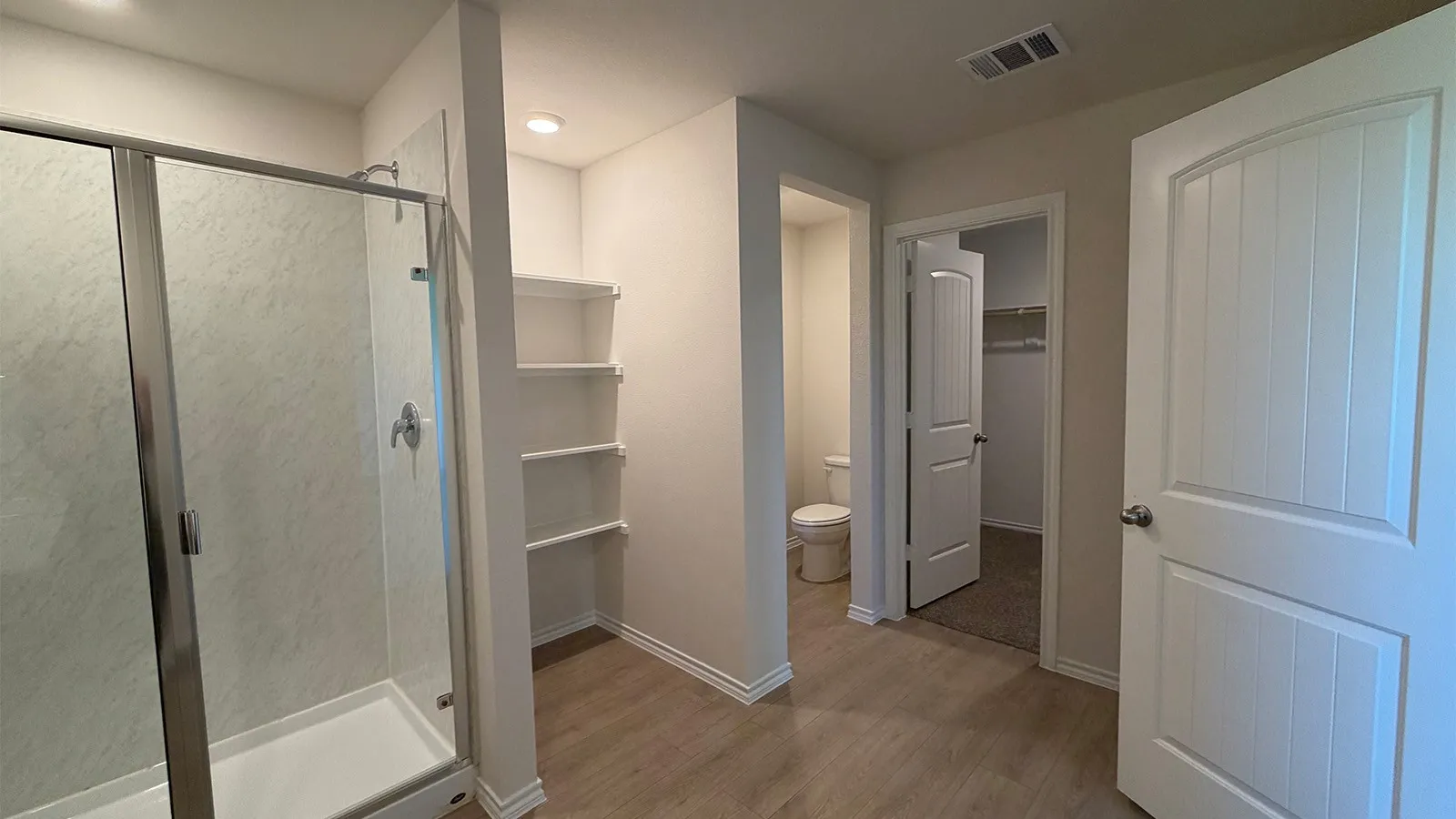 Shower enclosure with sliding glass door and contemporary shower fixtures