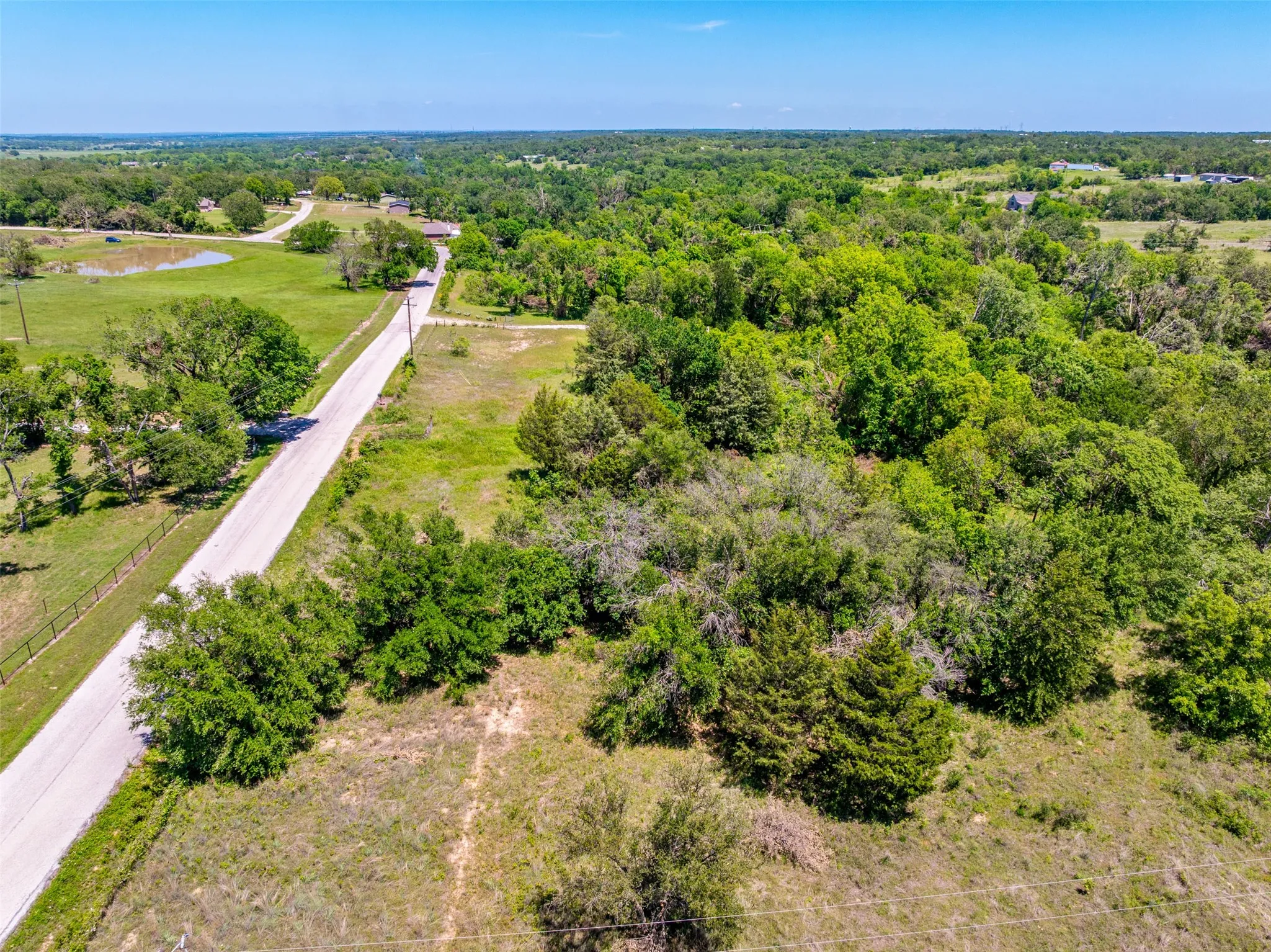 Expansive acreage featuring mature trees and a natural landscape