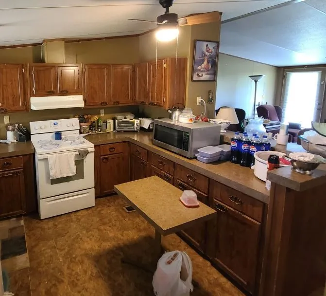 Kitchen featuring wood-finish cabinetry, laminate countertops, and a built-in range