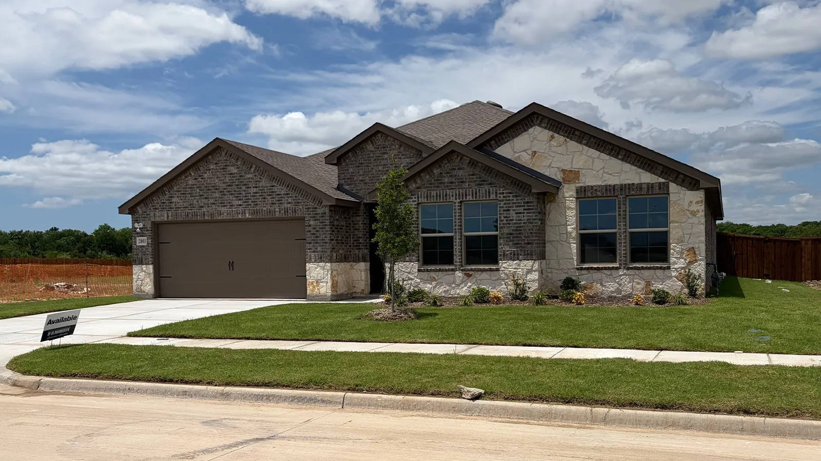 Contemporary single-story residence showcasing a mixed-material facade of dark brick and light-toned stone