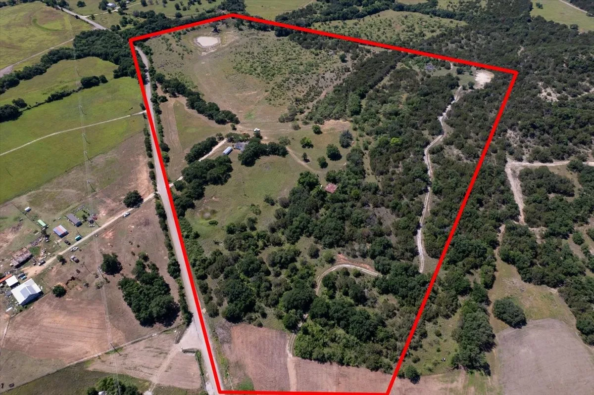 Expansive acreage featuring a mix of wooded areas and open fields