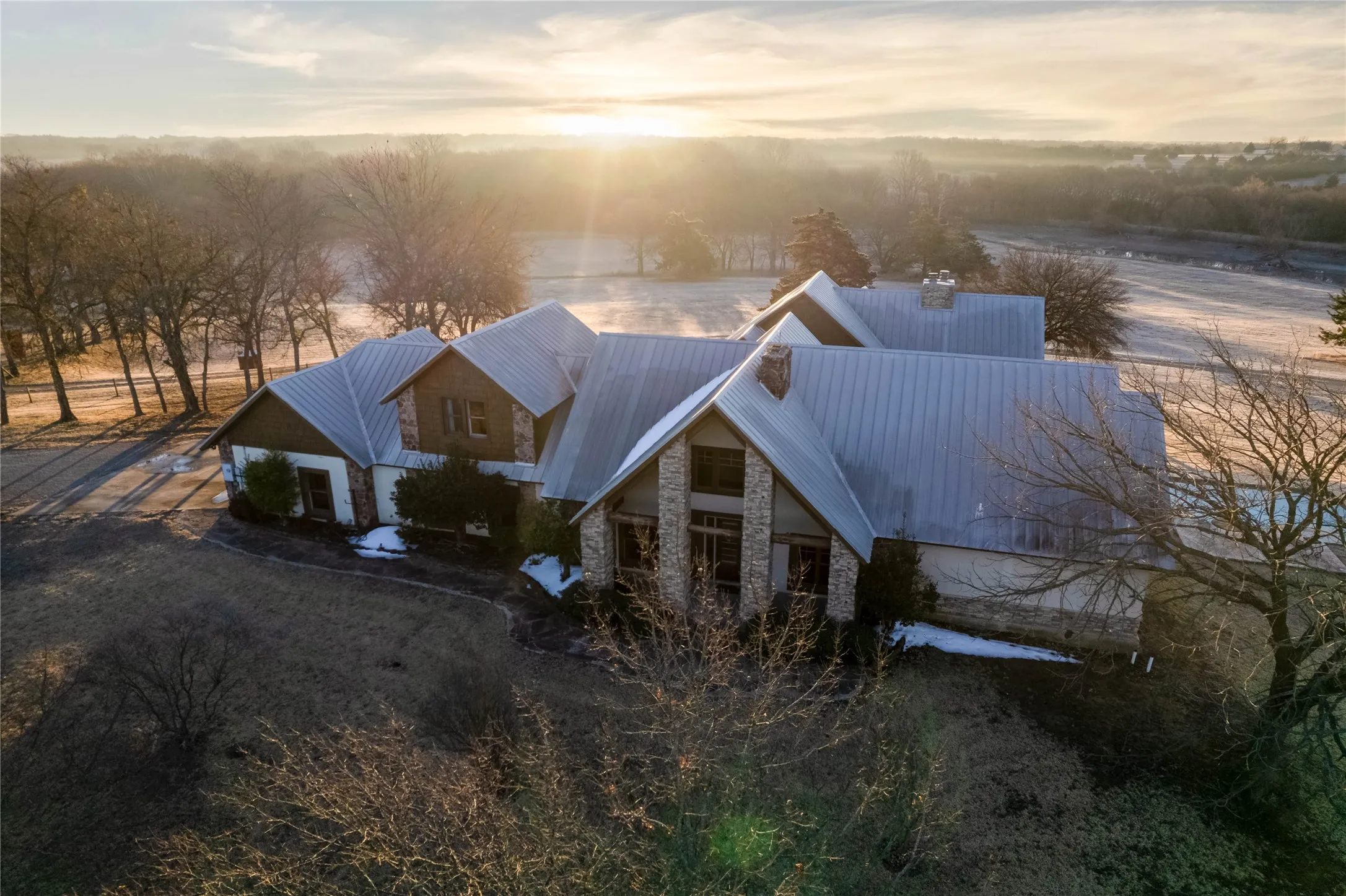Stone and siding exterior with a metal roof