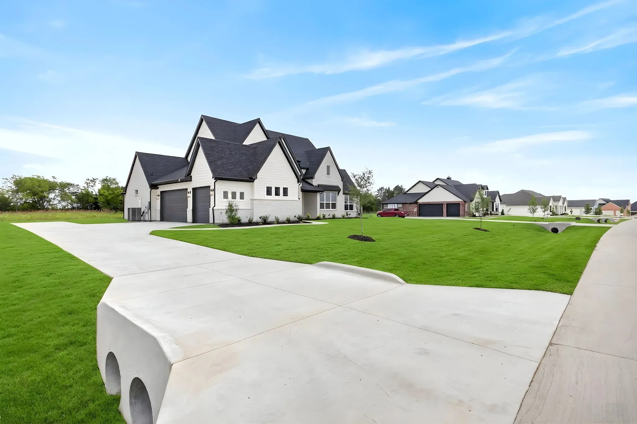 Modern farmhouse-style exterior featuring white siding and dark trim