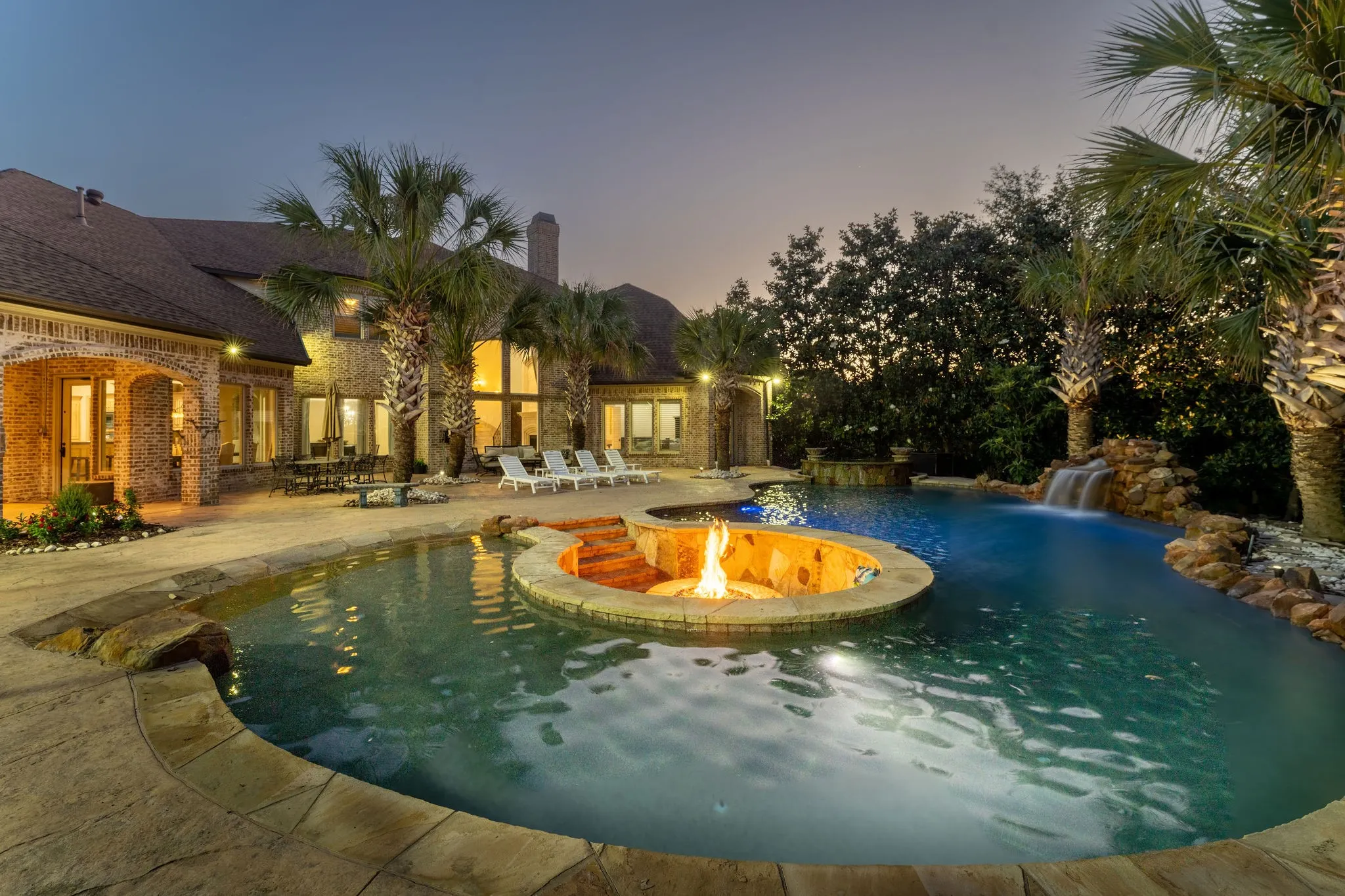 Resort pool, fire pit and seating , mature palms