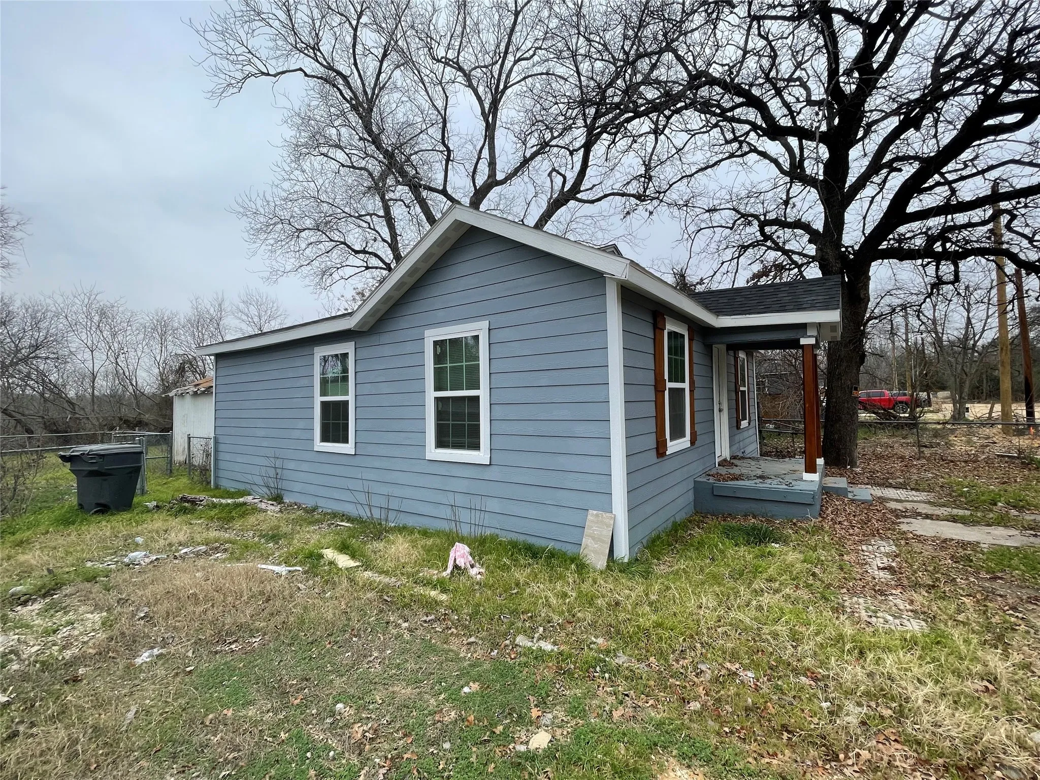 View of side of property featuring a lawn