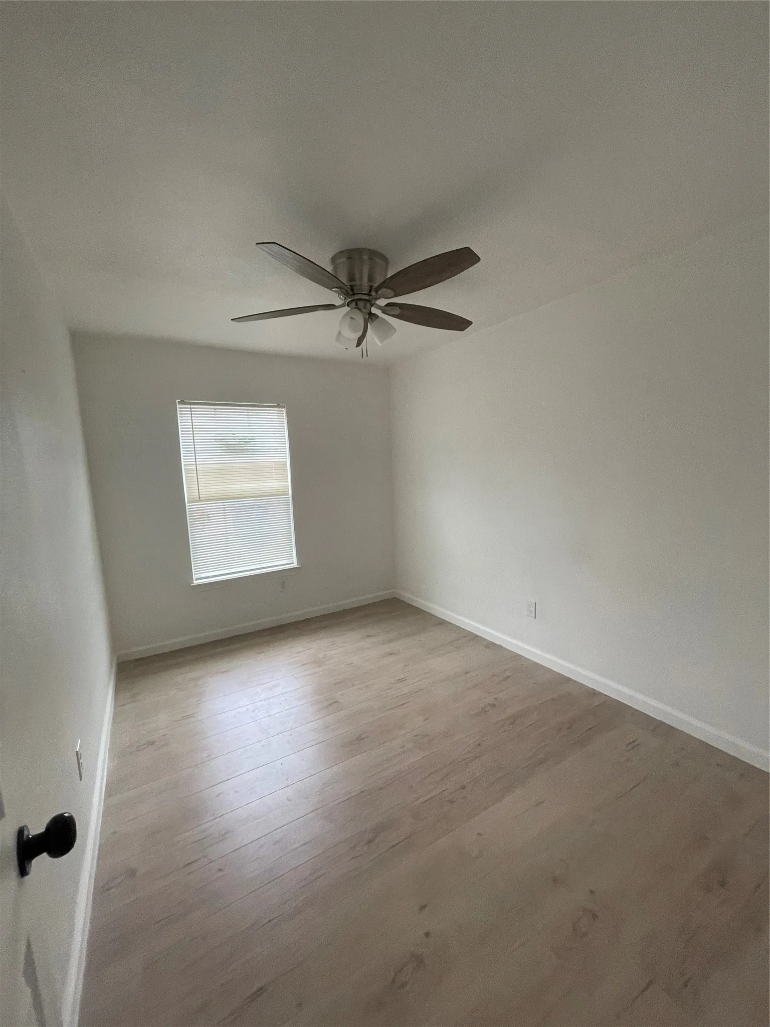 Bedroom with ceiling fan and light hardwood / wood-style floors