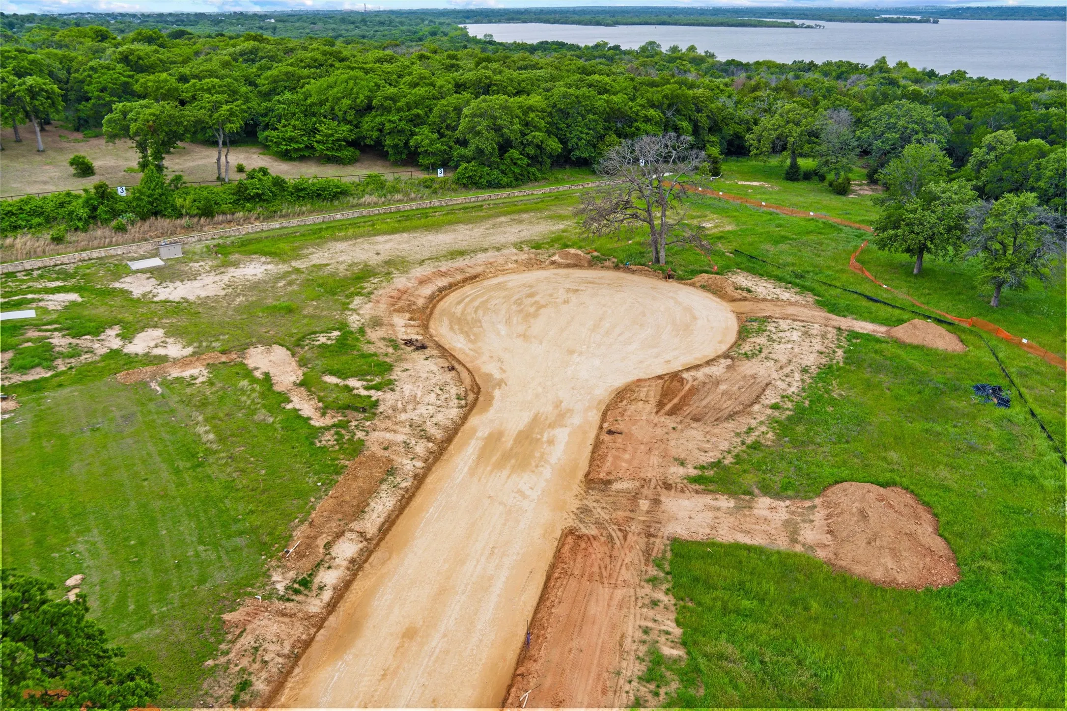 Land parcel featuring a newly graded cul-de-sac and developing access road