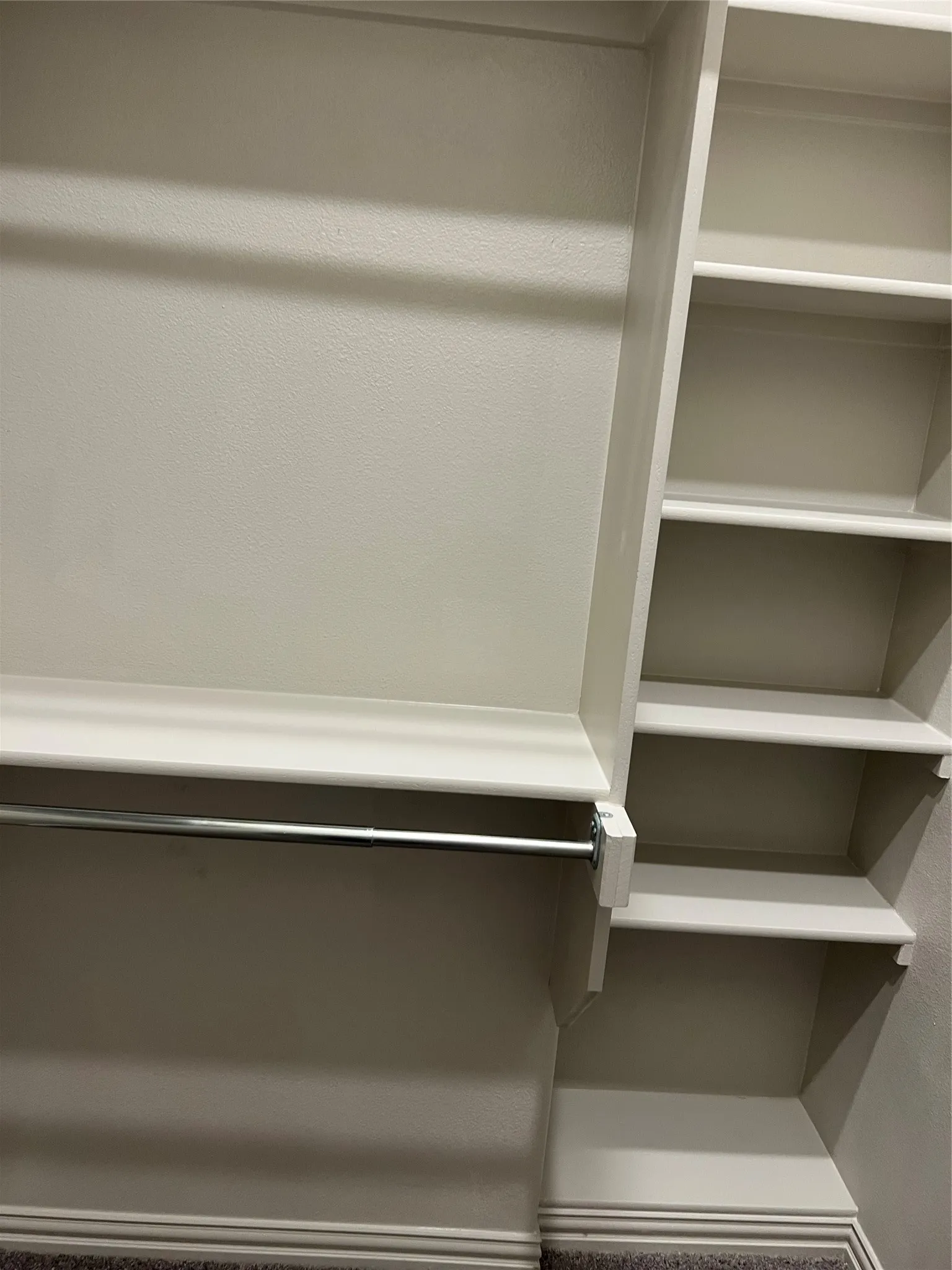 Built-in closet organization system featuring shelving and hanging rods