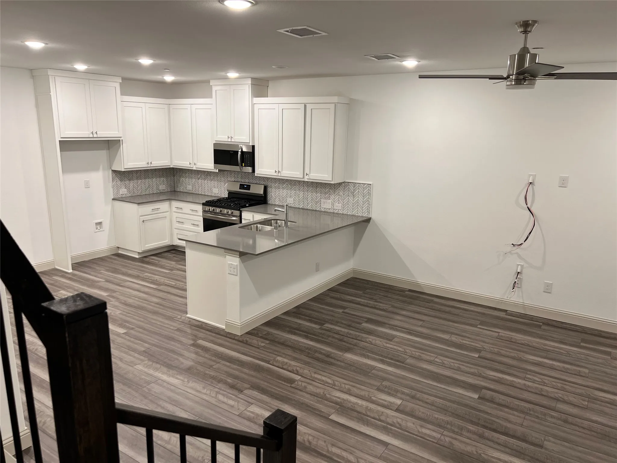 Open-concept living space featuring wood-finish flooring