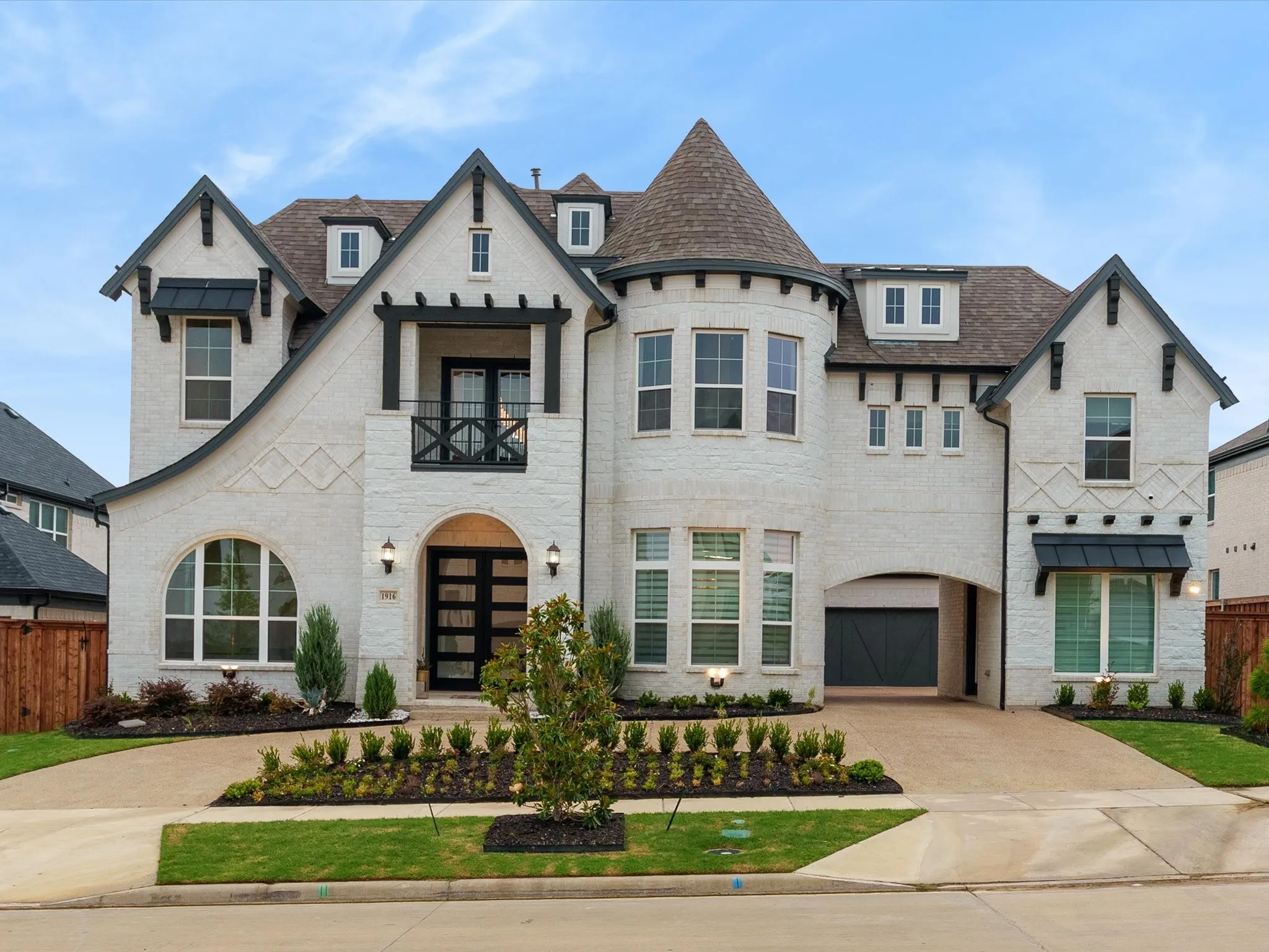 Two-story architectural design featuring a prominent turret and white brick facade