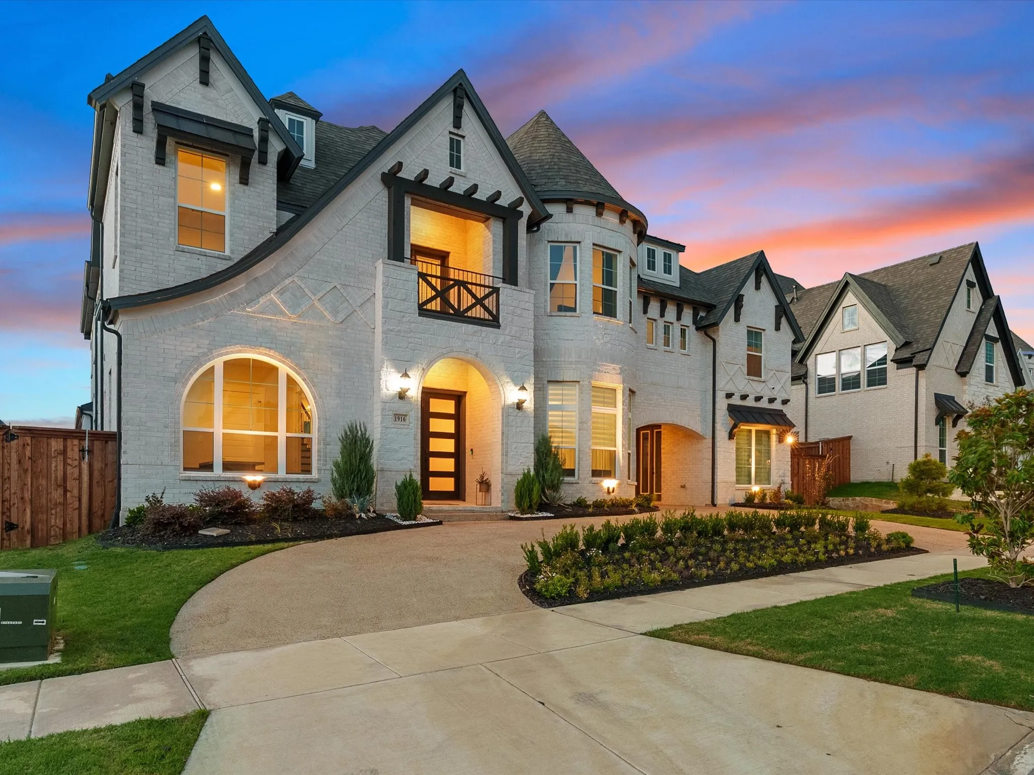 White brick exterior featuring gabled roofs and dark trim accents