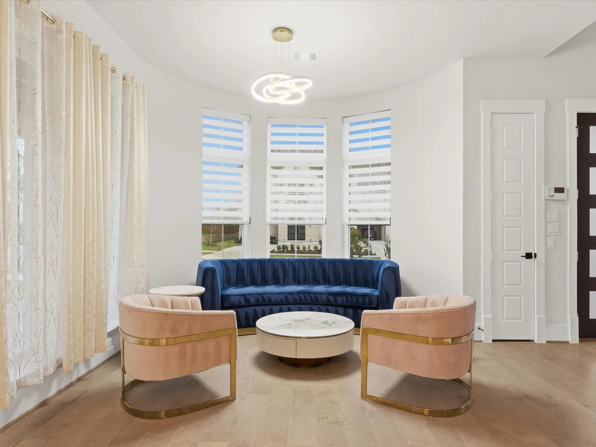 Curved wall with three windows featuring horizontal blinds