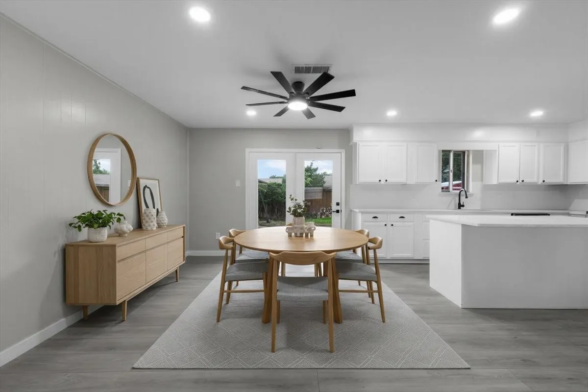 Open-concept dining area featuring wood-finish flooring, recessed lighting, and a contemporary ceiling fan