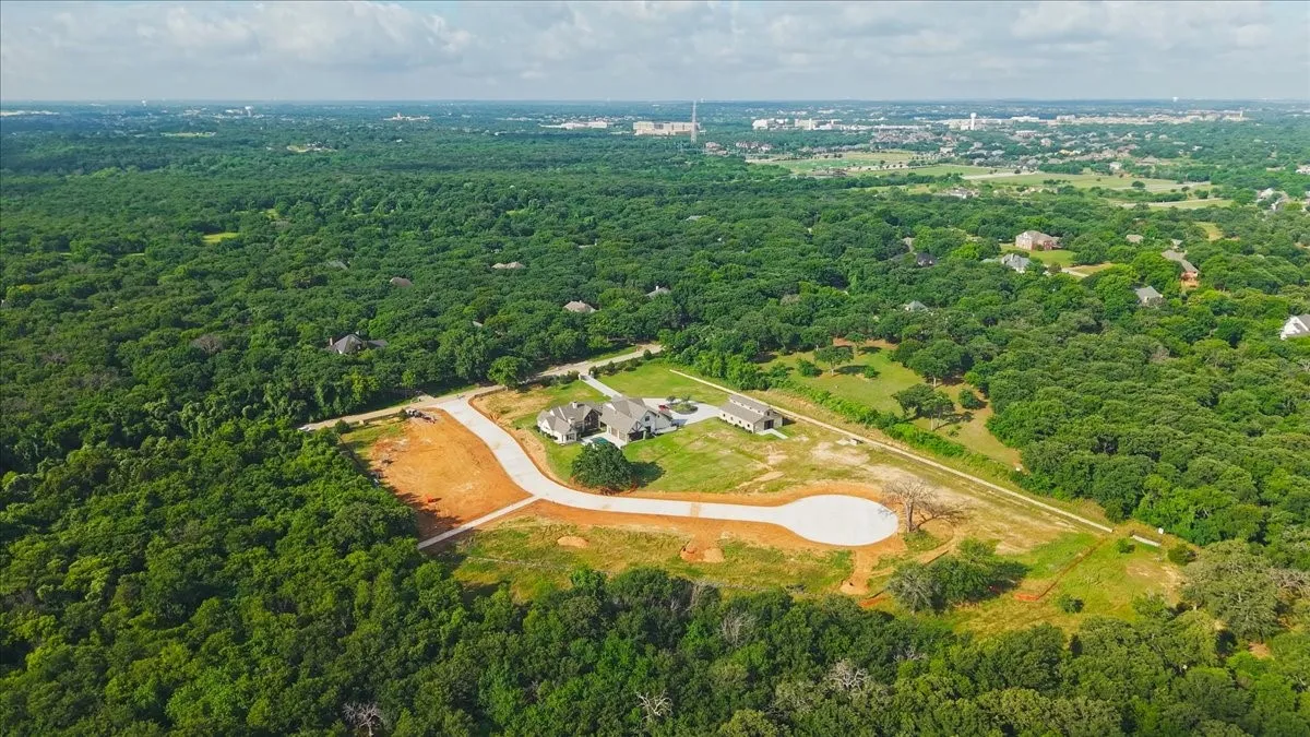Expansive property featuring a large residence, a separate auxiliary building, and a cul-de-sac driveway