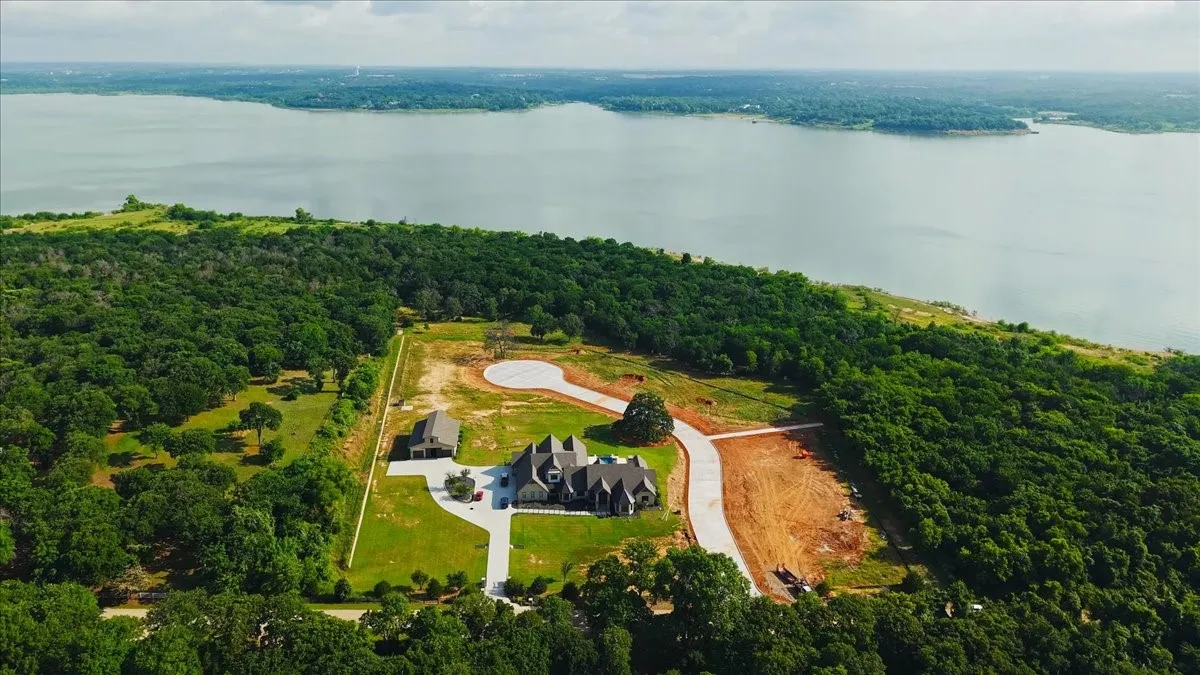 Expansive property with a large body of water bordering one side