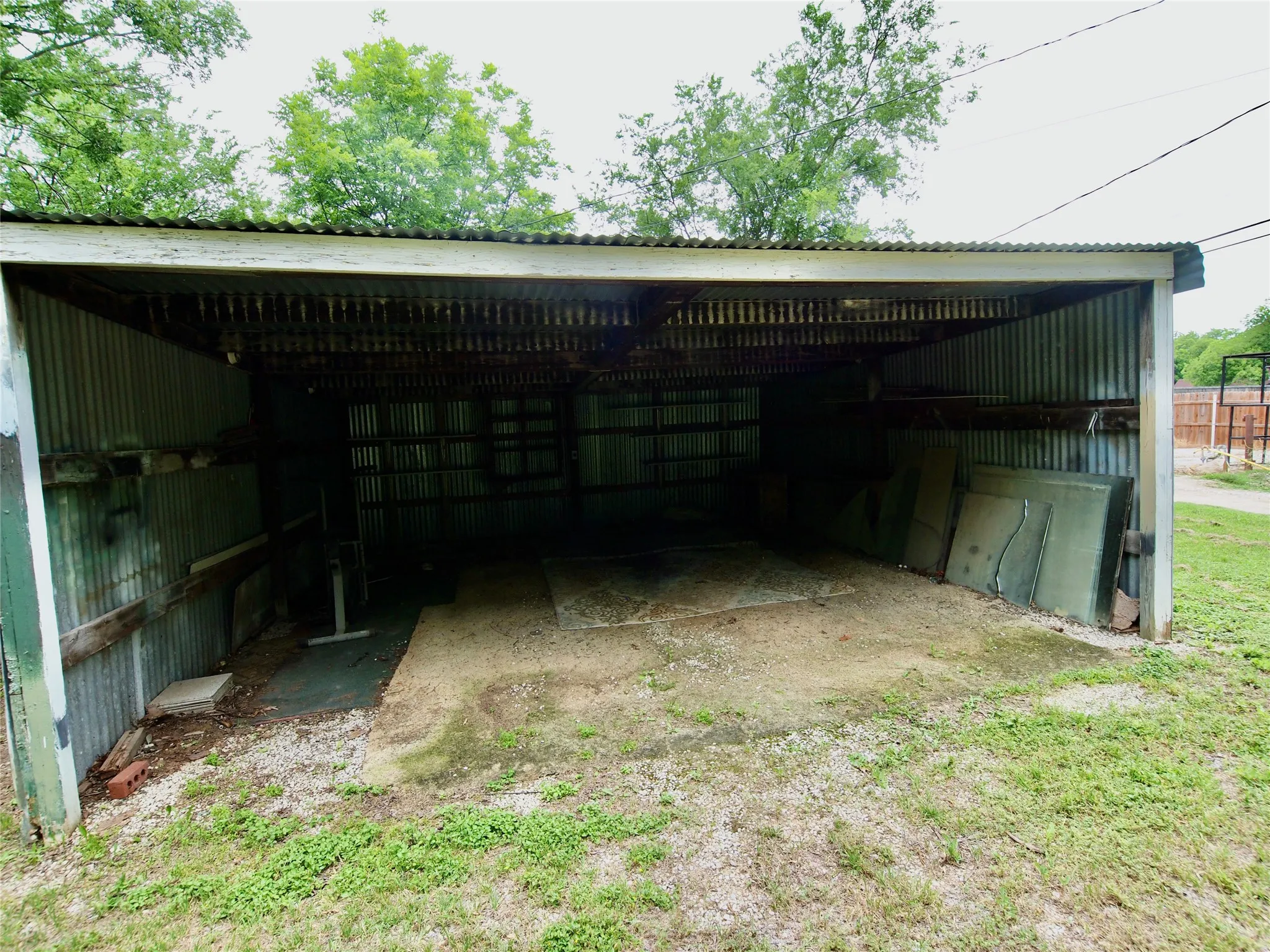 Two car metal carport near alley
