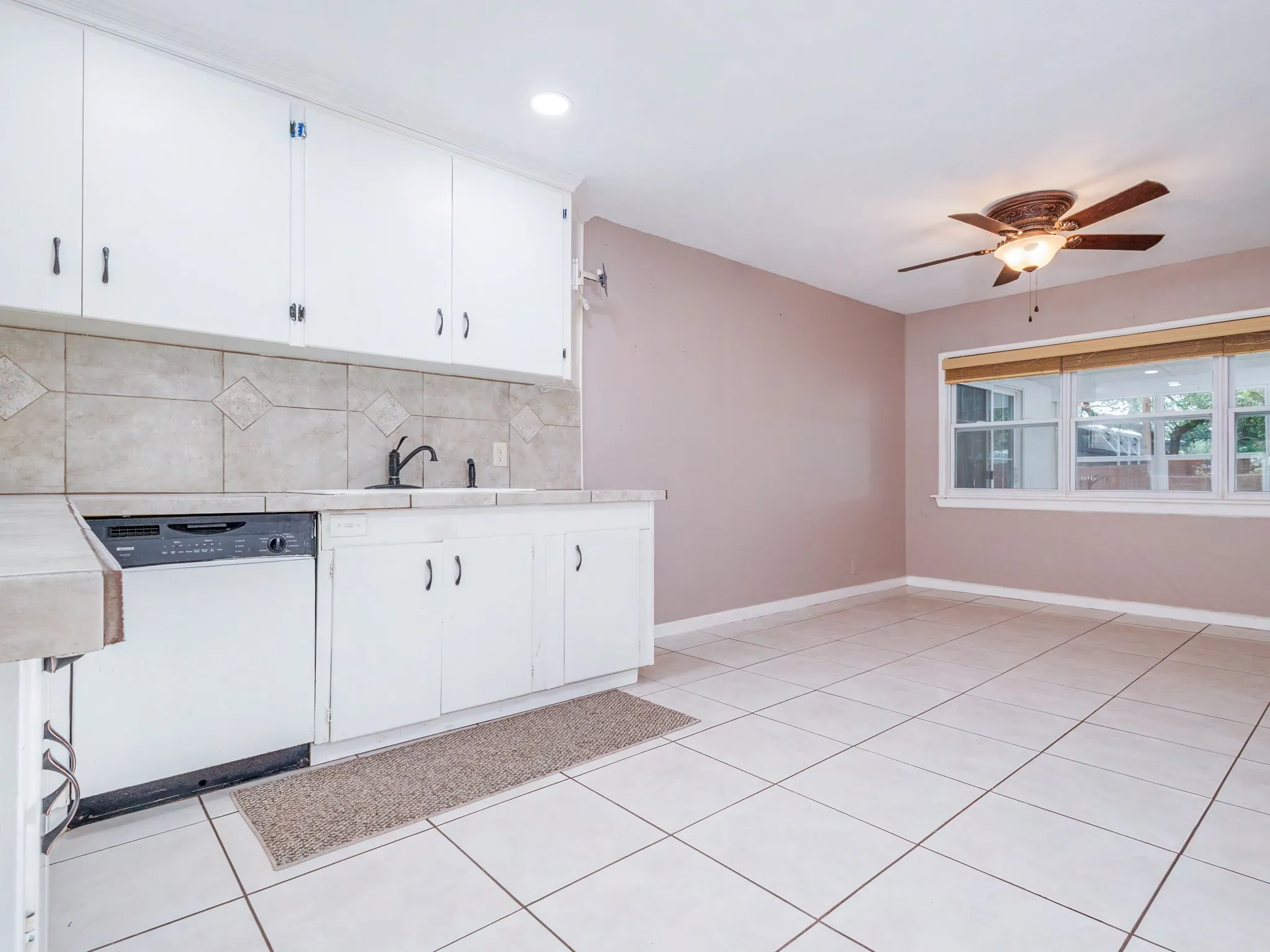 Kitchen with second dining area and windows into the sunroom.